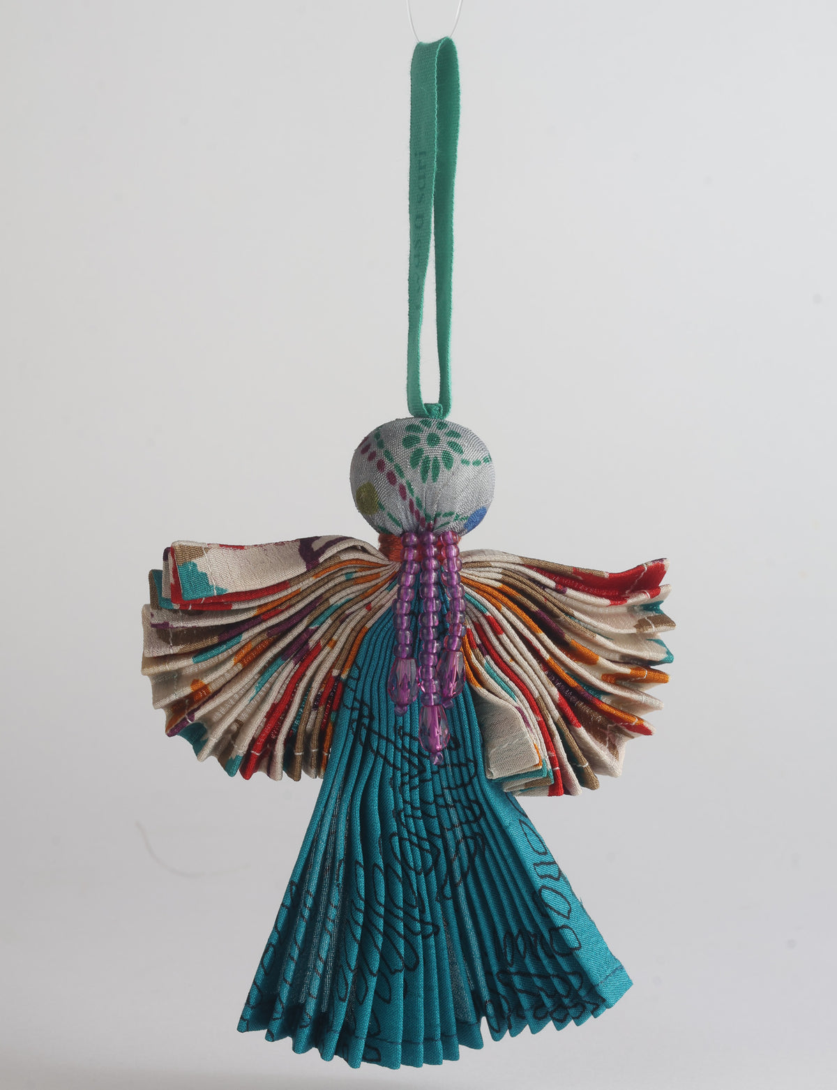 Angel Christmas Ornament made from upcycled saris, featuring pleated arms and body. A sustainable, eco-friendly holiday decoration, embodying recycled fashion and upcycling in festive style.





