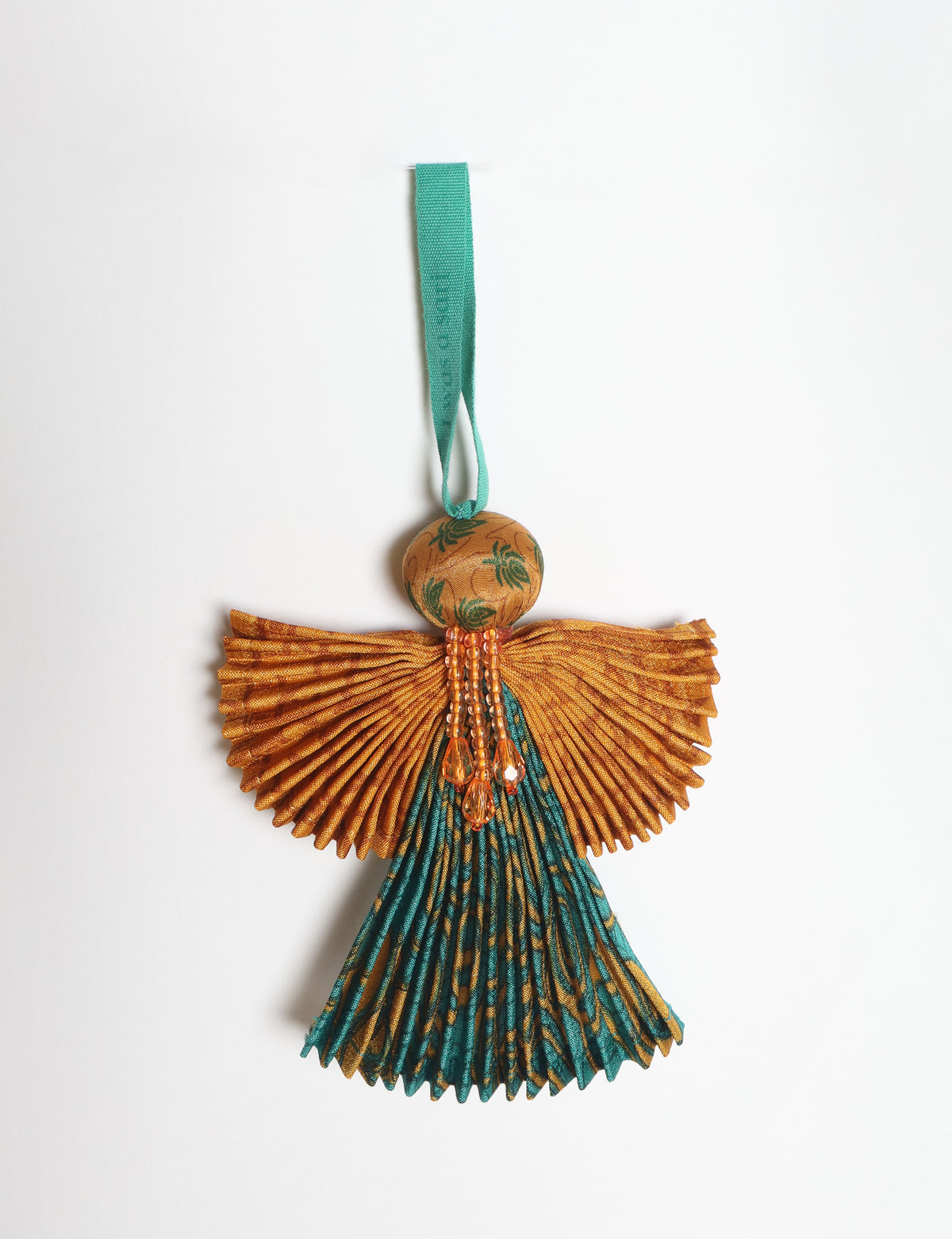 Angel Christmas Ornament made from upcycled saris, featuring pleated arms and body. A sustainable, eco-friendly holiday decoration, embodying recycled fashion and upcycling in festive style.





