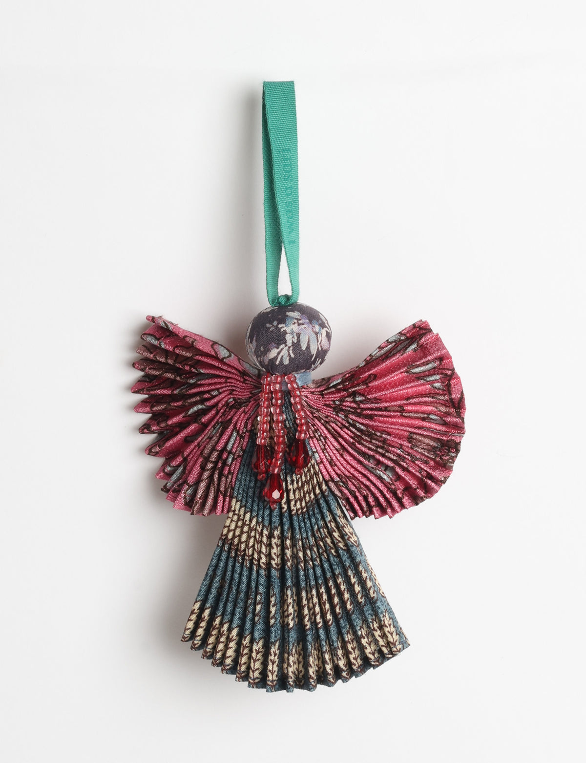 Angel Christmas Ornament made from upcycled saris, featuring pleated arms and body. A sustainable, eco-friendly holiday decoration, embodying recycled fashion and upcycling in festive style.






