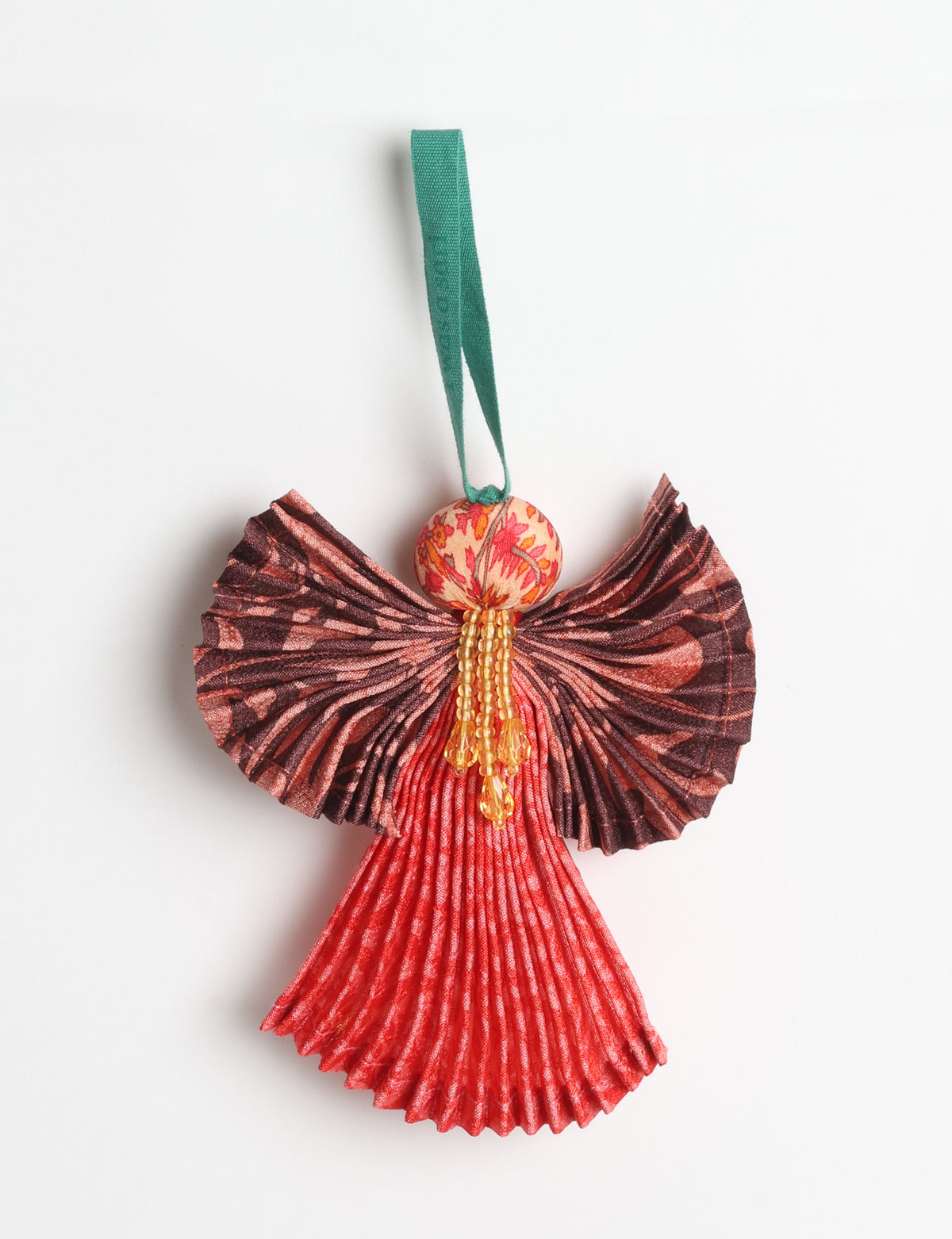 Angel Christmas Ornament made from upcycled saris, featuring pleated arms and body. A sustainable, eco-friendly holiday decoration, embodying recycled fashion and upcycling in festive style.





