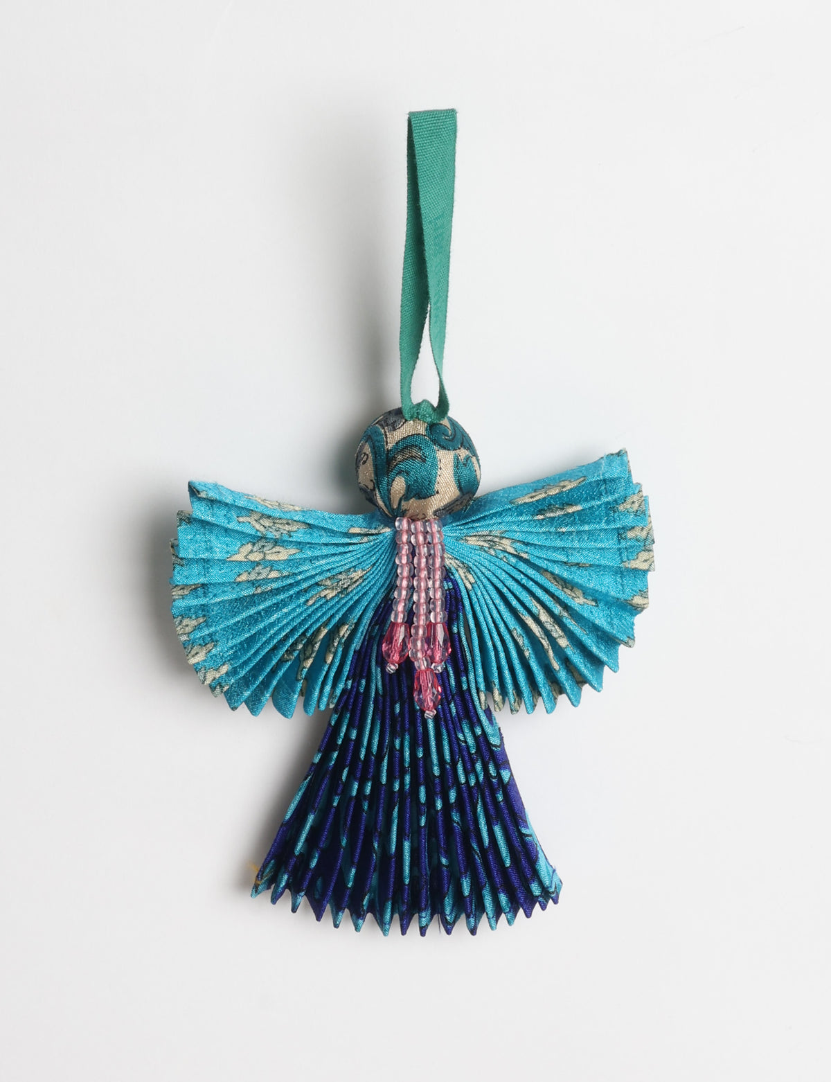 Angel Christmas Ornament made from upcycled saris, featuring pleated arms and body. A sustainable, eco-friendly holiday decoration, embodying recycled fashion and upcycling in festive style.





