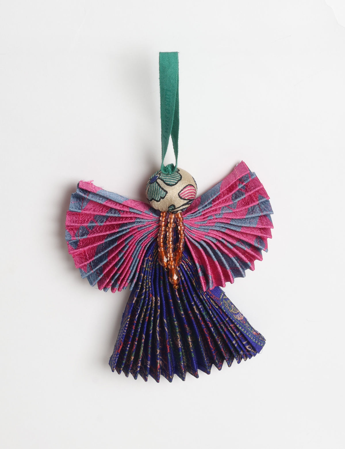 Angel Christmas Ornament made from upcycled saris, featuring pleated arms and body. A sustainable, eco-friendly holiday decoration, embodying recycled fashion and upcycling in festive style.





