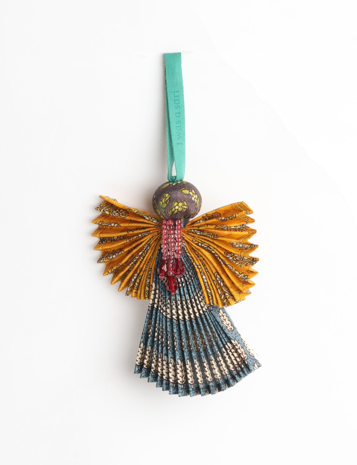 Angel Christmas Ornament made from upcycled saris, featuring pleated arms and body. A sustainable, eco-friendly holiday decoration, embodying recycled fashion and upcycling in festive style.





