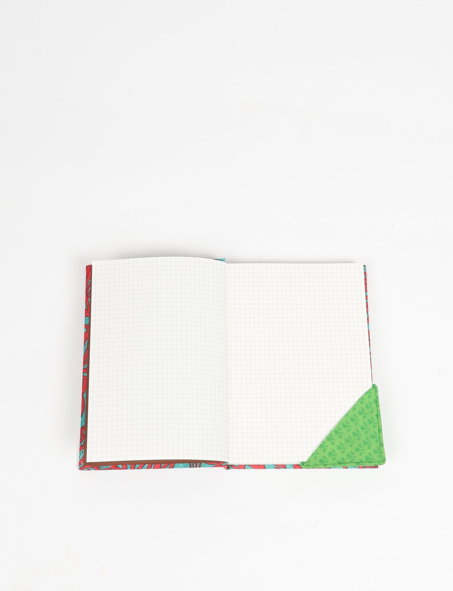 Colorful square-shaped corner bookmark made from recycled sari textiles, representing repurposed clothing, fair trade fashion, and ethical fashion. An earth-friendly product made from textile waste, aligning with carbon neutral clothing values.