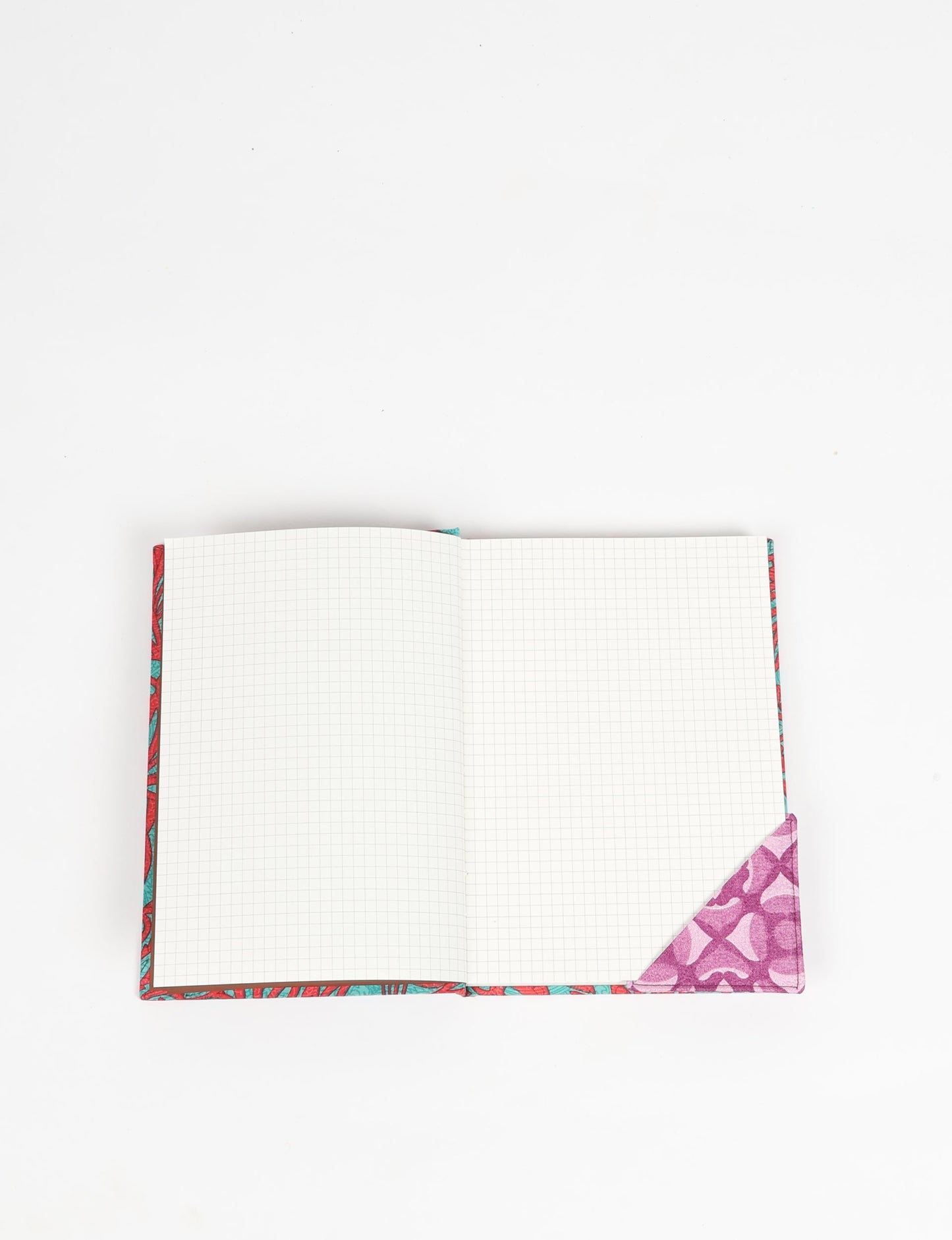 Colorful square-shaped corner bookmark made from recycled sari textiles, representing repurposed clothing, fair trade fashion, and ethical fashion. An earth-friendly product made from textile waste, aligning with carbon neutral clothing values.