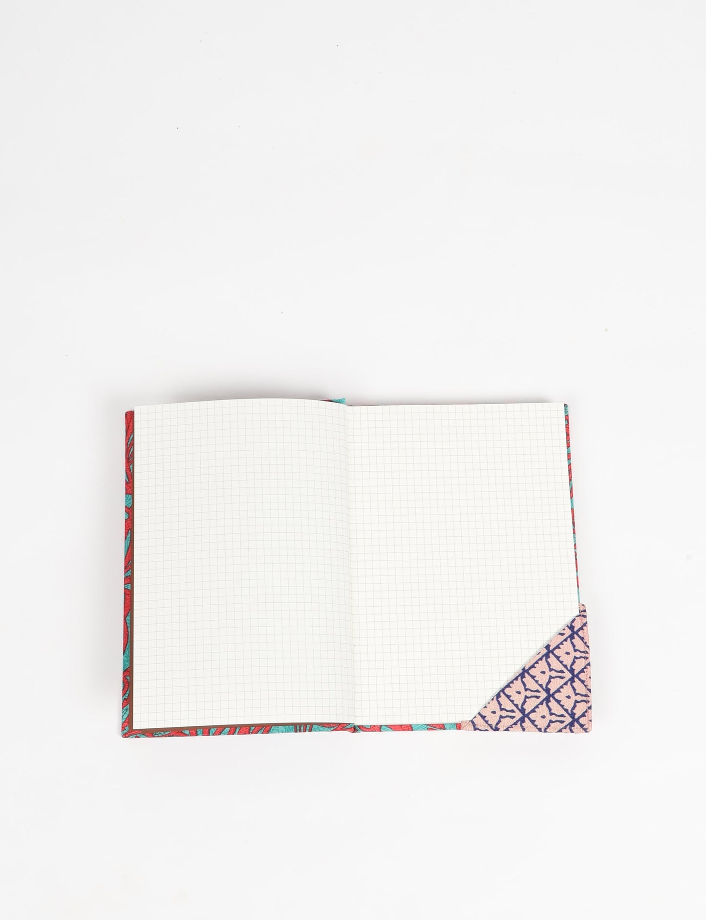 Colorful square-shaped corner bookmark made from recycled sari textiles, representing repurposed clothing, fair trade fashion, and ethical fashion. An earth-friendly product made from textile waste, aligning with carbon neutral clothing values.