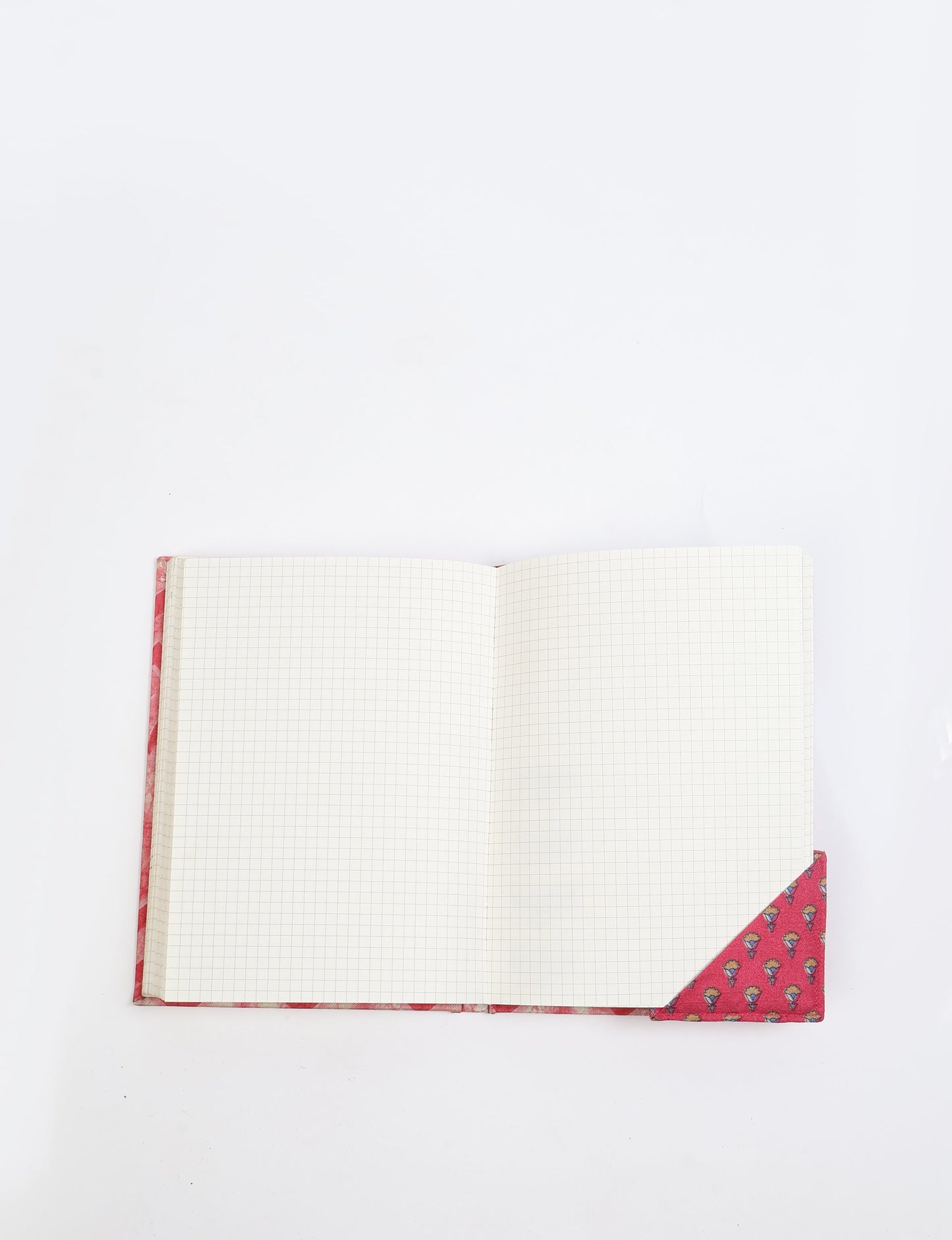Colorful square-shaped corner bookmark made from recycled sari textiles, representing repurposed clothing, fair trade fashion, and ethical fashion. An earth-friendly product made from textile waste, aligning with carbon neutral clothing values.