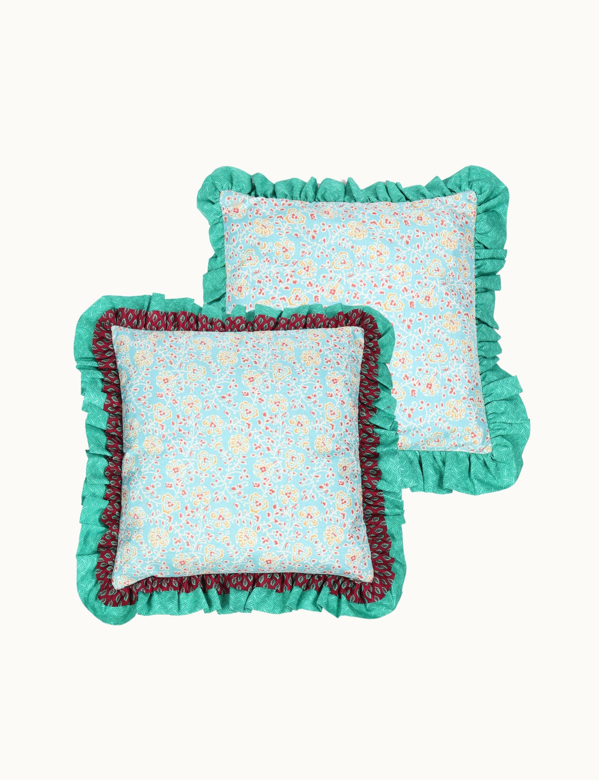 Set of two blue floral cushion covers with double frill edges in green and maroon, shown flat lay