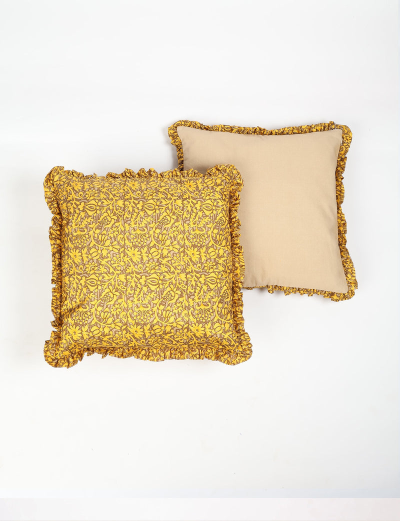 Set of two square cushion covers with yellow floral pattern and solid beige back, featuring yellow frill trim, flat lay view