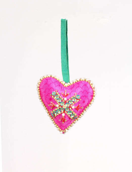 A Christmas heart ornament made from recycled sari fabric, featuring traditional Aari embroidery, representing sustainable, eco-friendly fashion. Handcrafted by artisans, this zero-waste, fair trade product symbolizes recycled material clothing and conscious clothing choices within eco-friendly and circular fashion.