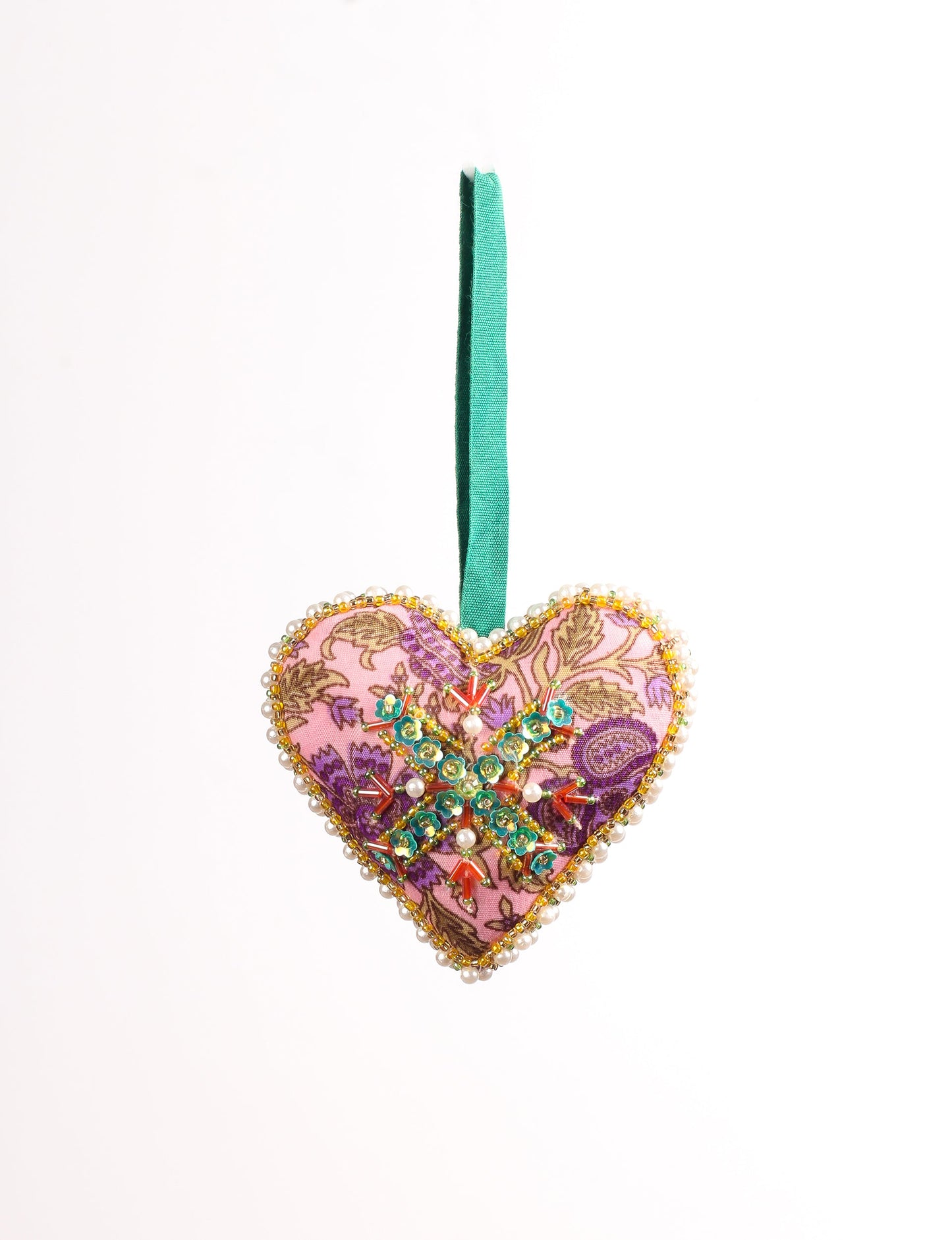 A Christmas heart ornament made from recycled sari fabric, featuring traditional Aari embroidery, representing sustainable, eco-friendly fashion. Handcrafted by artisans, this zero-waste, fair trade product symbolizes recycled material clothing and conscious clothing choices within eco-friendly and circular fashion.