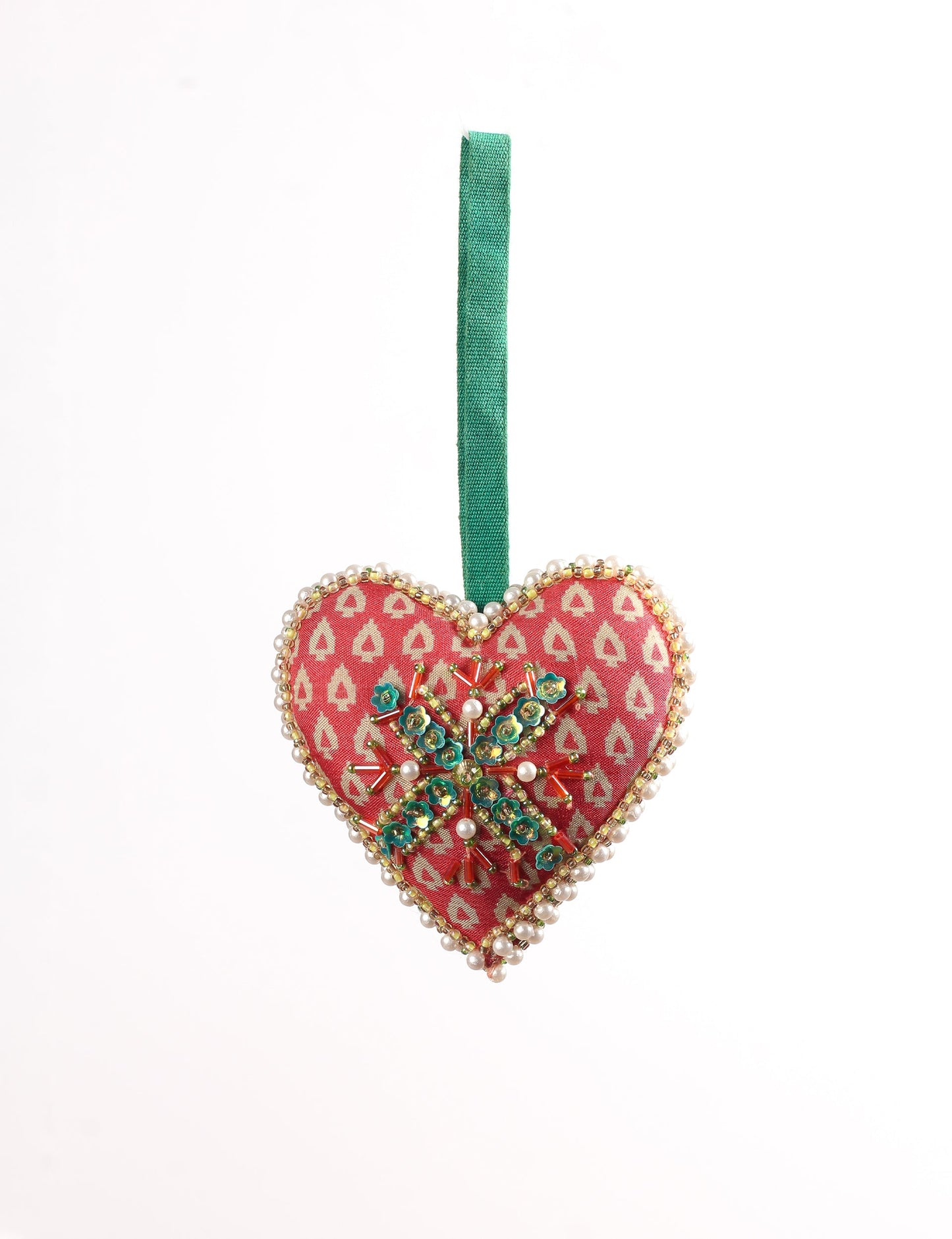 A Christmas heart ornament made from recycled sari fabric, featuring traditional Aari embroidery, representing sustainable, eco-friendly fashion. Handcrafted by artisans, this zero-waste, fair trade product symbolizes recycled material clothing and conscious clothing choices within eco-friendly and circular fashion.