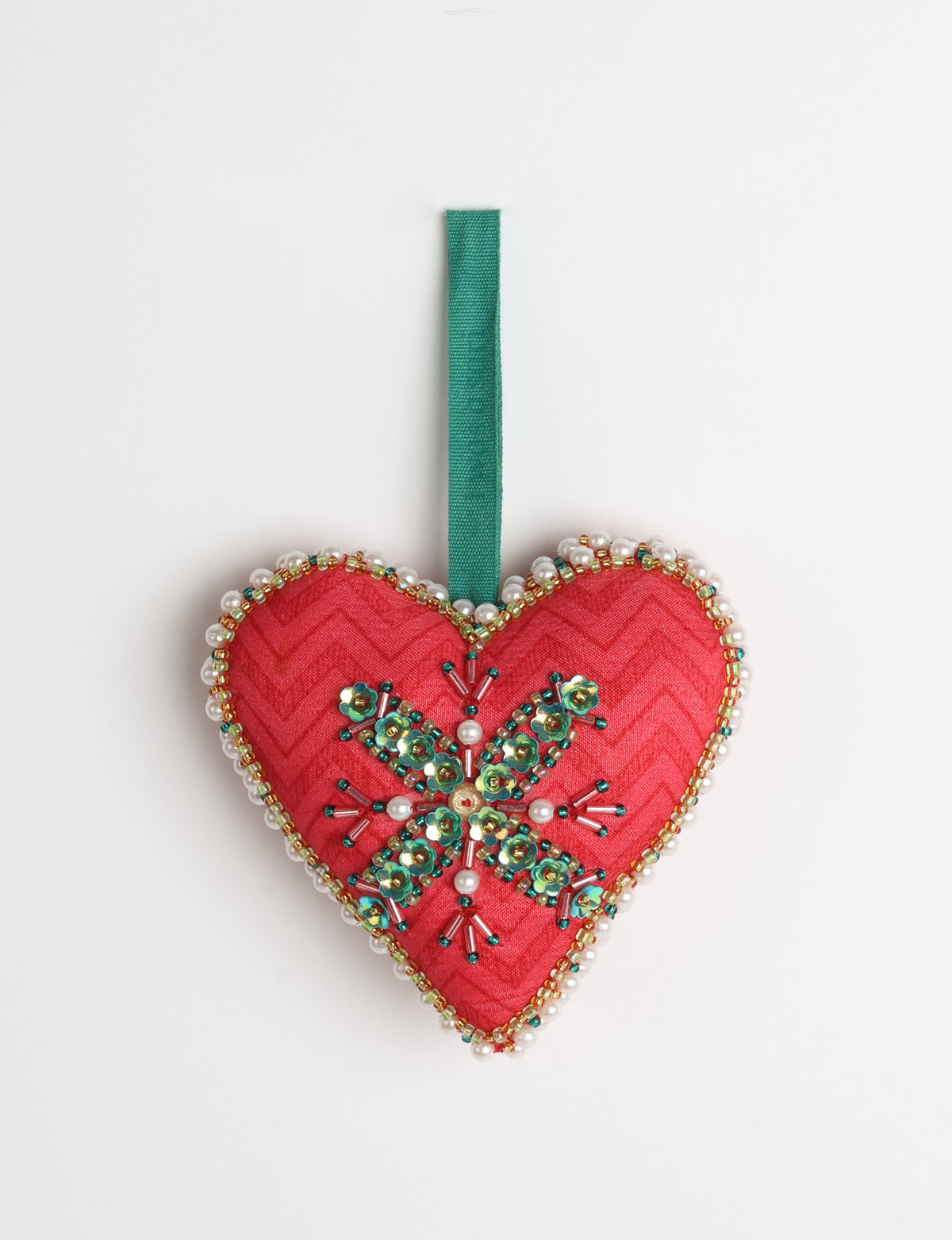 Red fabric heart ornament with yellow floral print, green and pearl bead embellishments, and green hanging loop