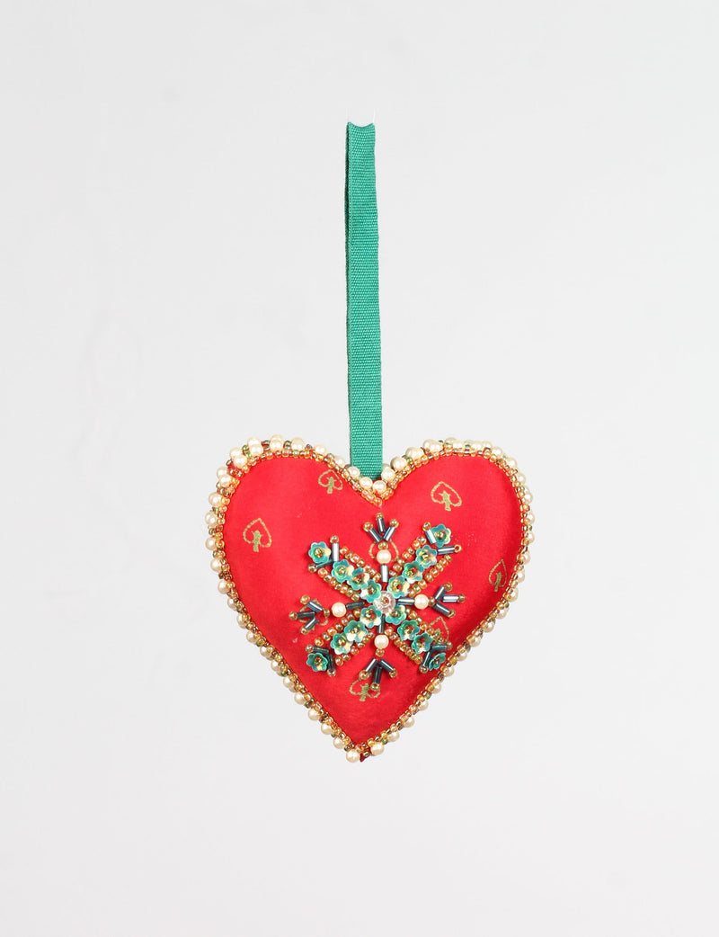 Red heart-shaped ornament with gold spade patterns, beaded pearl and gold trim, and a green floral bead snowflake design