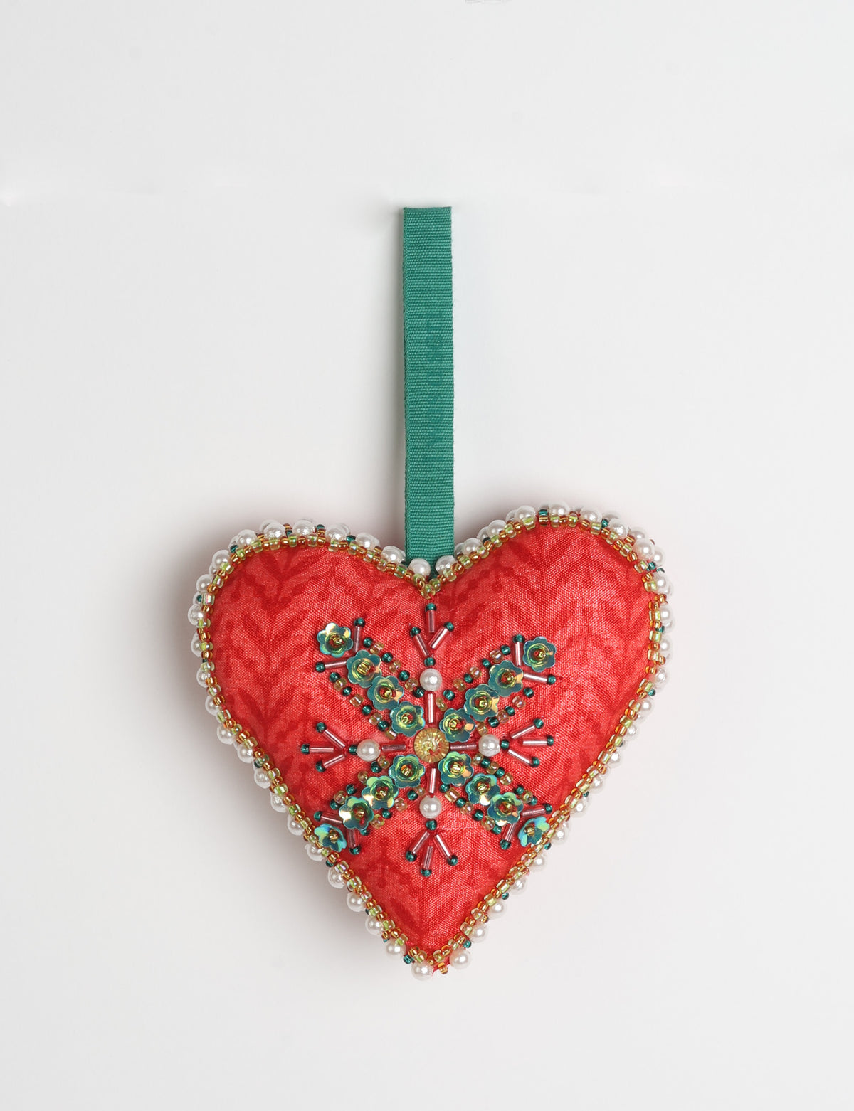 Red fabric heart ornament with yellow floral print, green and pearl bead embellishments, and green hanging loop