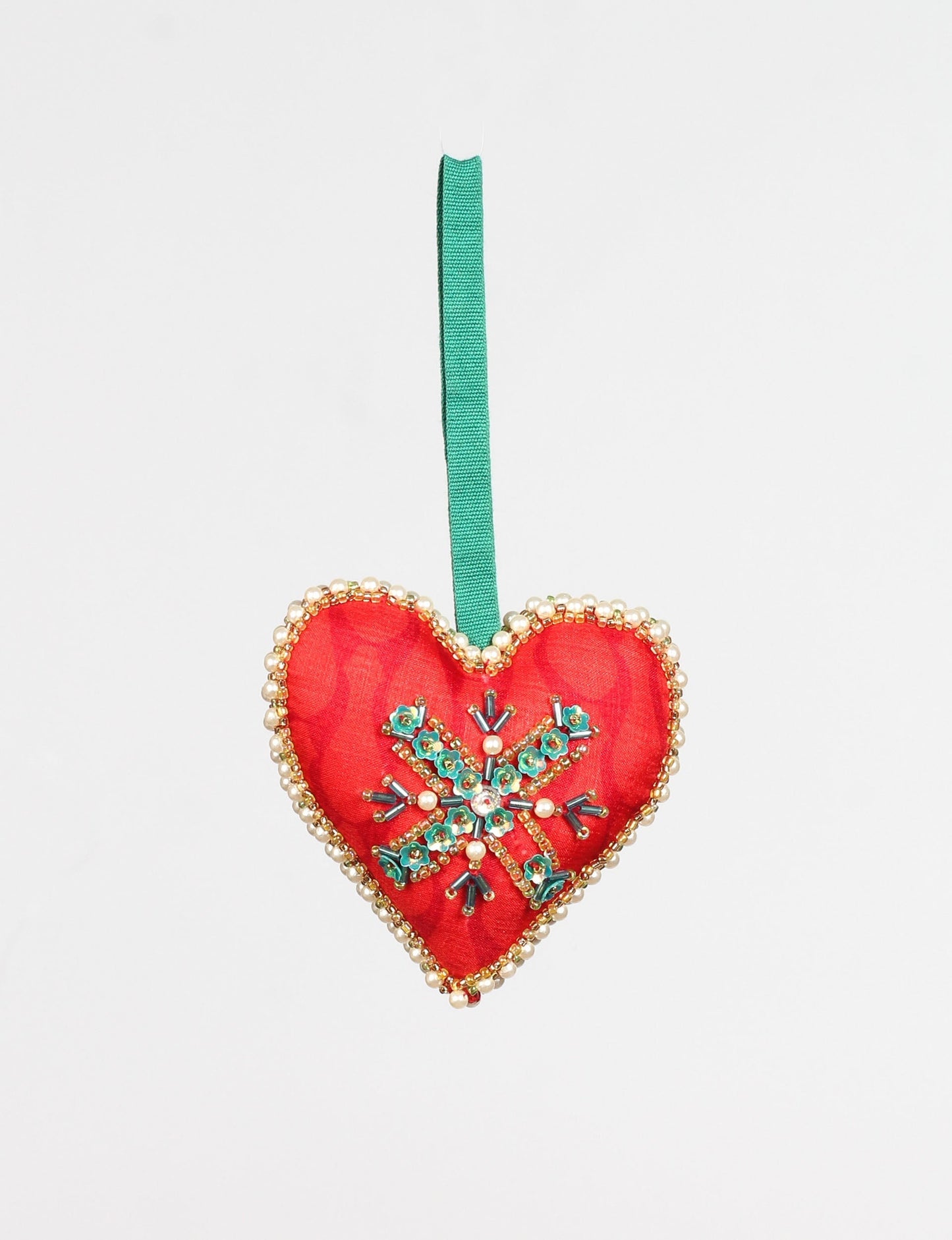 Handcrafted heart ornament made from recycled sari products, featuring traditional Aari embroidery. This upcycled women's clothing inspired piece is a carbon neutral fashion statement, supporting environmentally friendly clothing and sustainable women's clothing. A perfect addition to your eco friendly fashion collection, promoting fashion revolution and repurposed clothing.