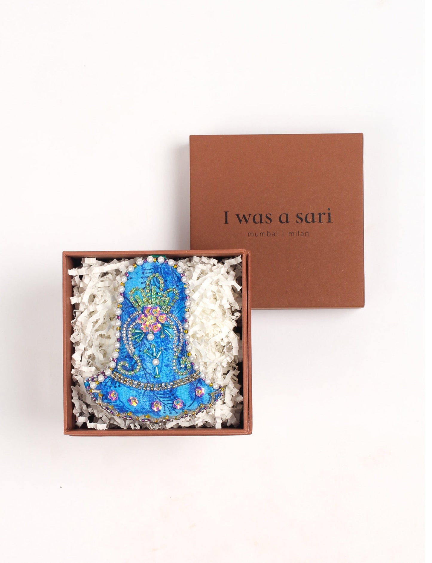 Bell-shaped Christmas ornament made from recycled saris, showcasing Aari embroidery, sustainable apparel, and green fashion. A celebration of upcycled clothing and eco-friendly products with a focus on sustainable women’s clothing and recycled fashion.