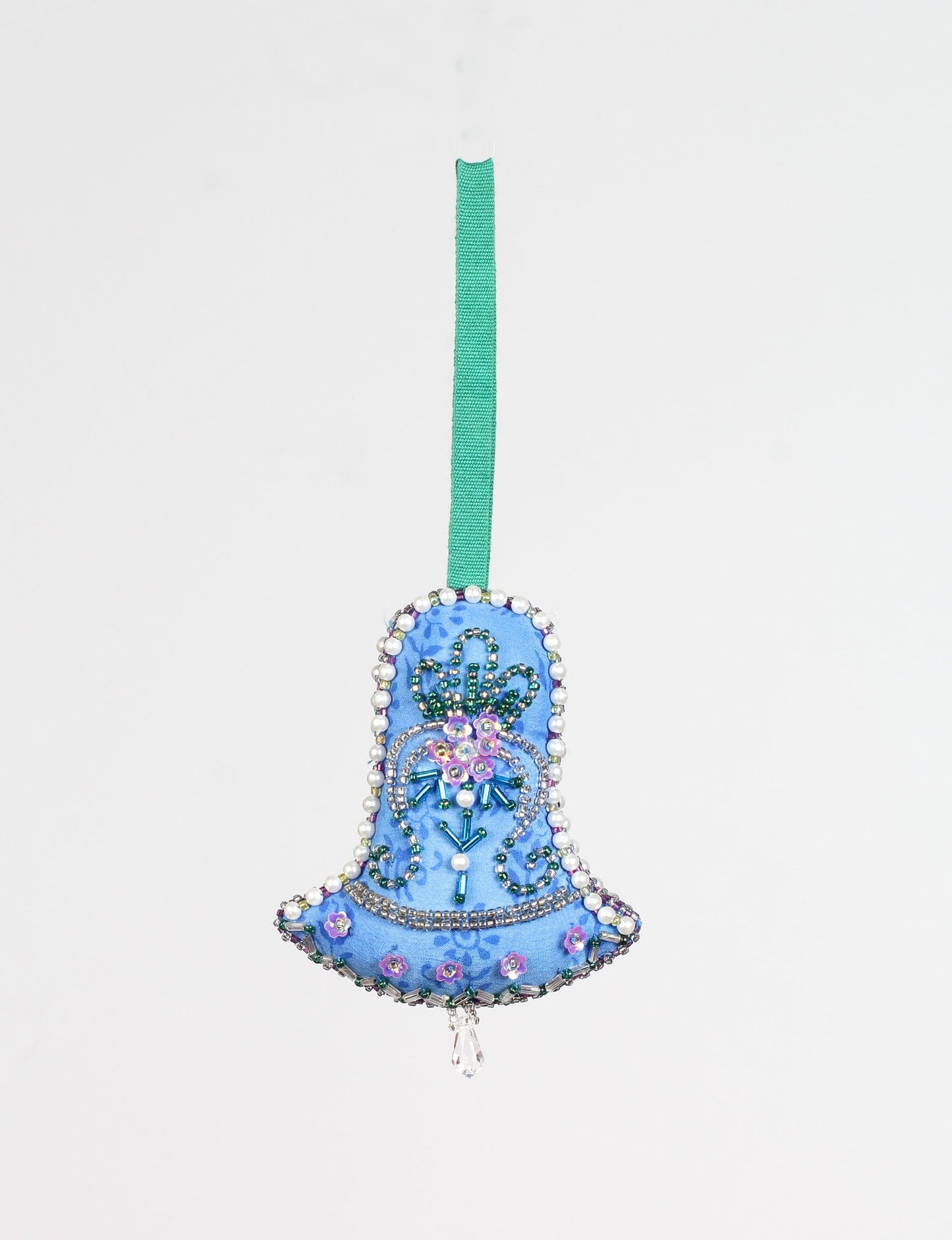 Bell-shaped Christmas ornament made from recycled saris, showcasing Aari embroidery, sustainable apparel, and green fashion. A celebration of upcycled clothing and eco-friendly products with a focus on sustainable women’s clothing and recycled fashion.