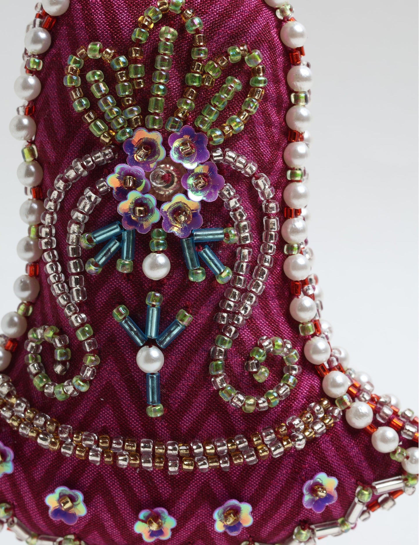 Bell-shaped Christmas ornament made from recycled saris, showcasing Aari embroidery, sustainable apparel, and green fashion. A celebration of upcycled clothing and eco-friendly products with a focus on sustainable women’s clothing and recycled fashion.