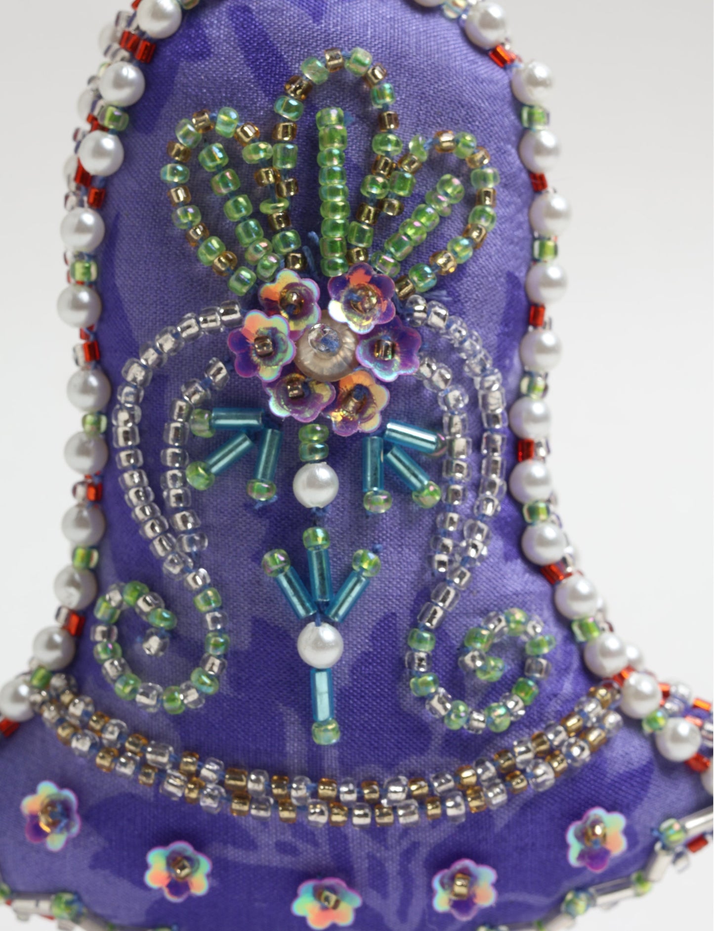 Bell-shaped Christmas ornament made from recycled saris, showcasing Aari embroidery, sustainable apparel, and green fashion. A celebration of upcycled clothing and eco-friendly products with a focus on sustainable women’s clothing and recycled fashion.