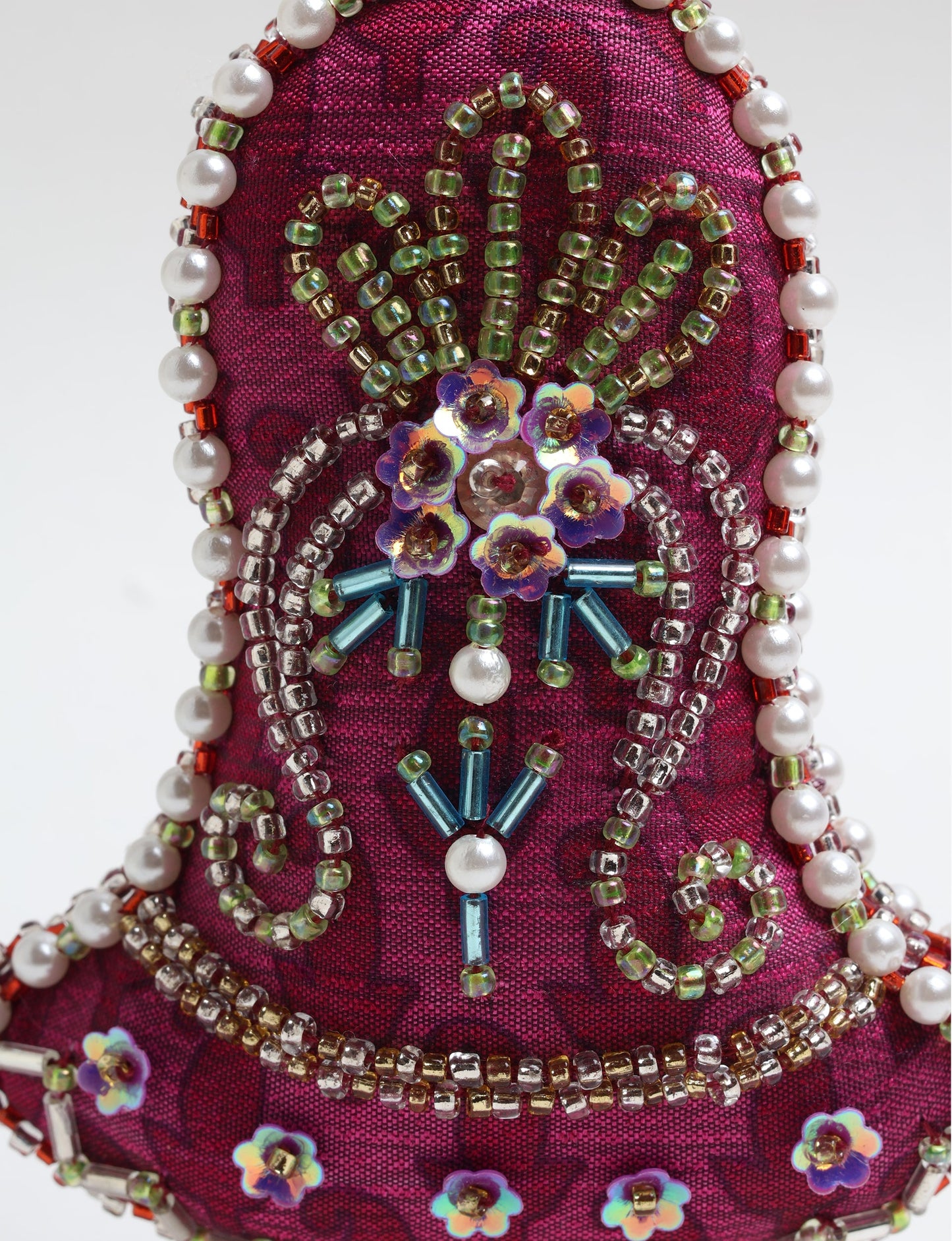 Bell-shaped Christmas ornament made from recycled saris, showcasing Aari embroidery, sustainable apparel, and green fashion. A celebration of upcycled clothing and eco-friendly products with a focus on sustainable women’s clothing and recycled fashion.