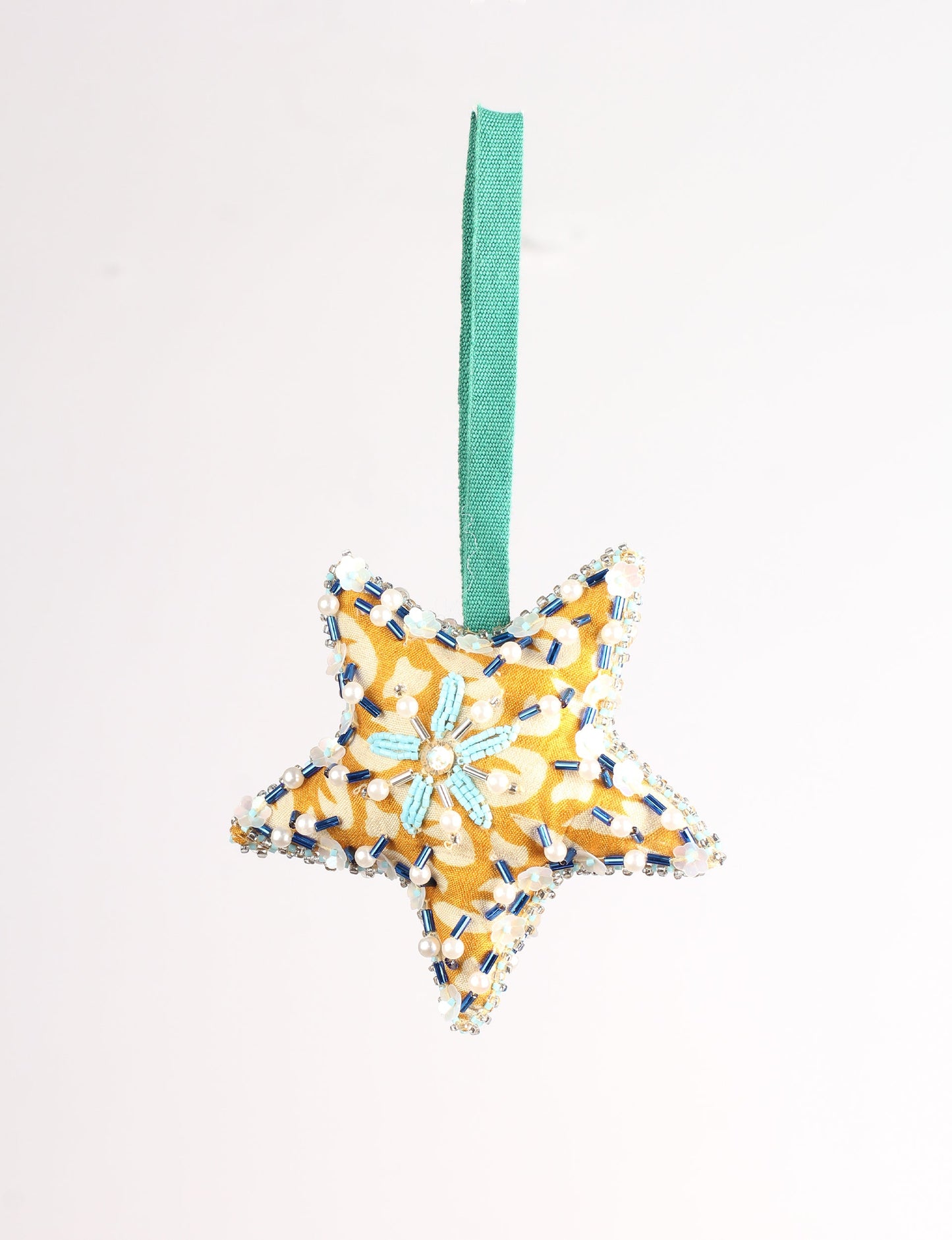 Christmas Star Ornaments made from upcycled saris with hand-embroidered Aari work, showcasing sustainable fashion and eco-friendly craftsmanship for ethical and green holiday decor.