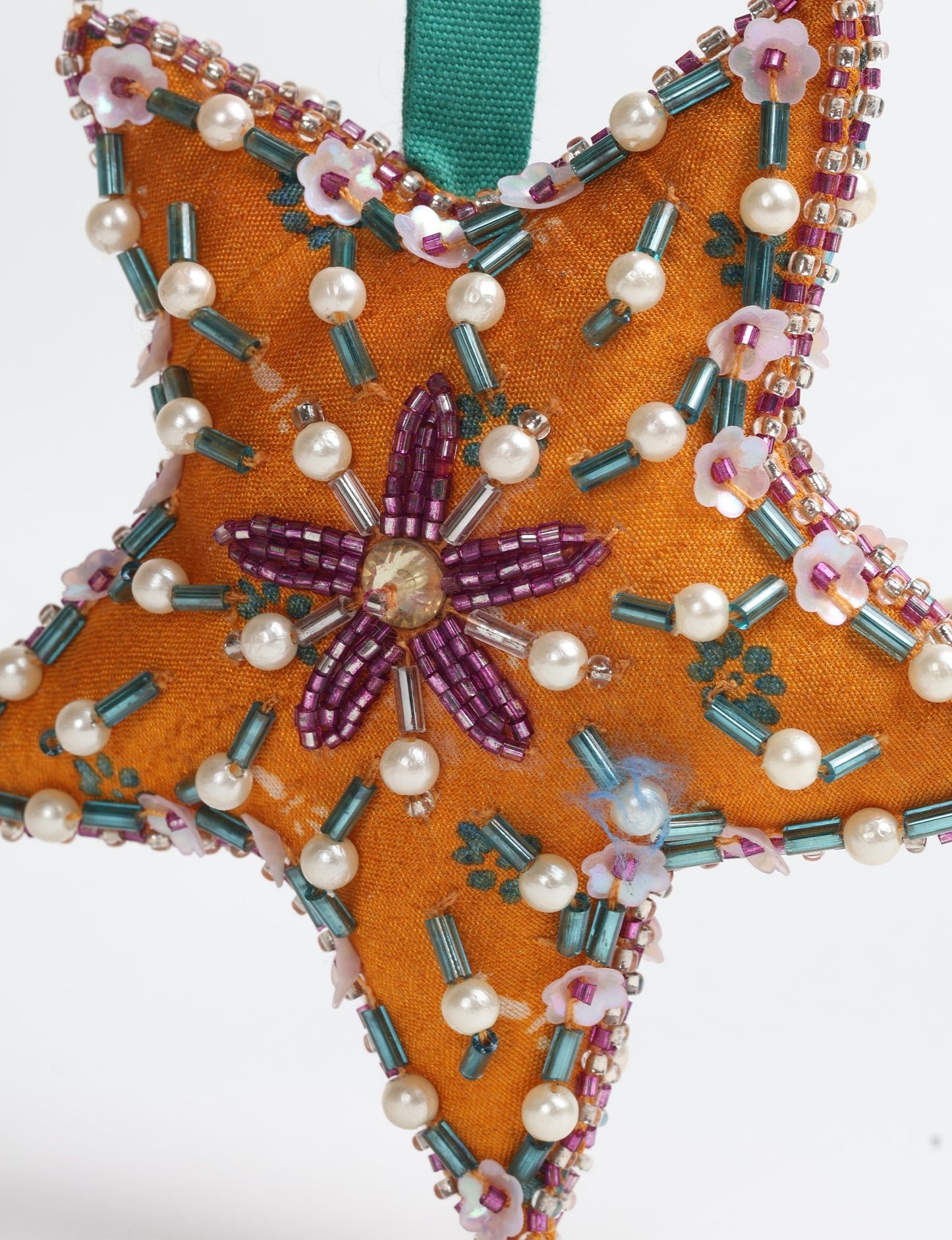 Christmas Star Ornaments made from upcycled saris with hand-embroidered Aari work, showcasing sustainable fashion and eco-friendly craftsmanship for ethical and green holiday decor.