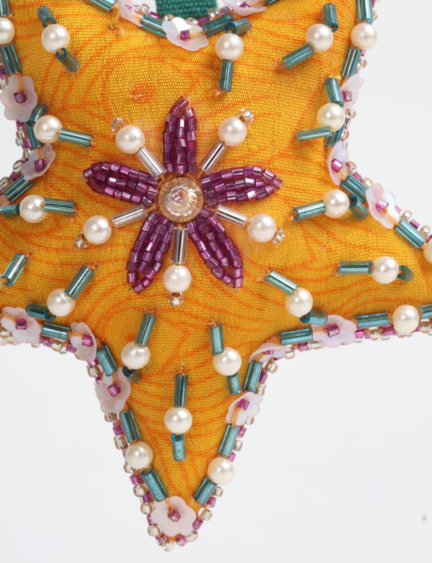 Christmas Star Ornaments made from upcycled saris with hand-embroidered Aari work, showcasing sustainable fashion and eco-friendly craftsmanship for ethical and green holiday decor.