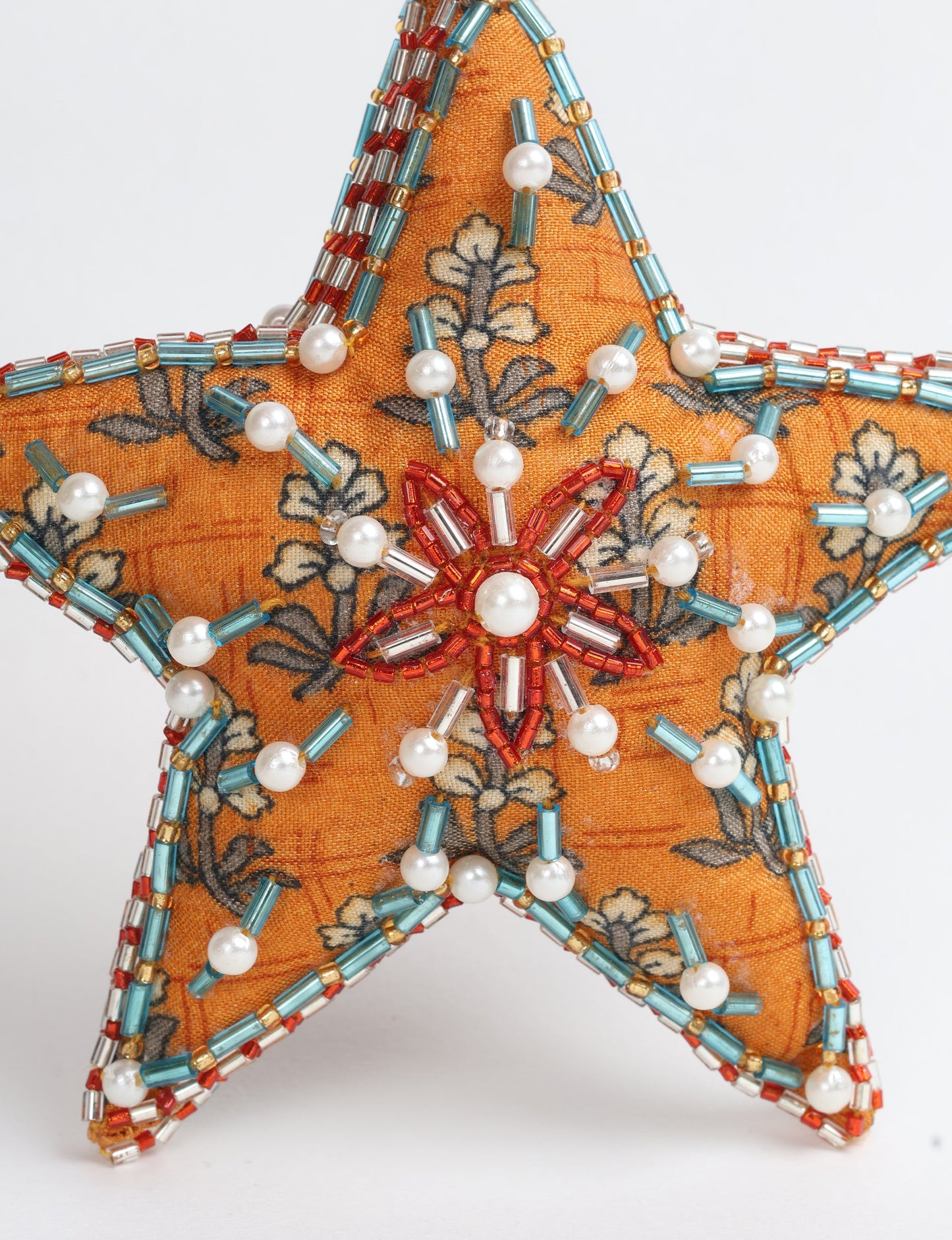 Christmas Star Ornaments made from upcycled saris with hand-embroidered Aari work, showcasing sustainable fashion and eco-friendly craftsmanship for ethical and green holiday decor.