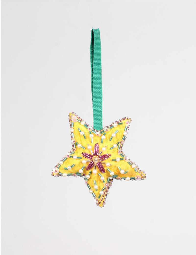 Yellow fabric star ornament with green, pink, and pearl bead embellishments and a green hanging loop