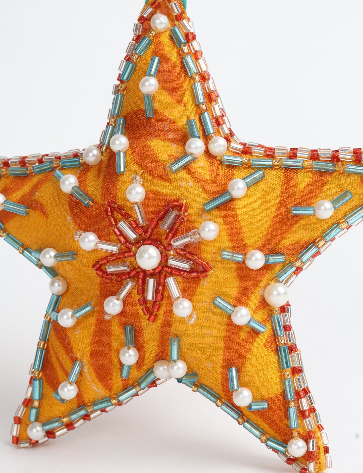 Christmas Star Ornaments made from upcycled saris with hand-embroidered Aari work, showcasing sustainable fashion and eco-friendly craftsmanship for ethical and green holiday decor.