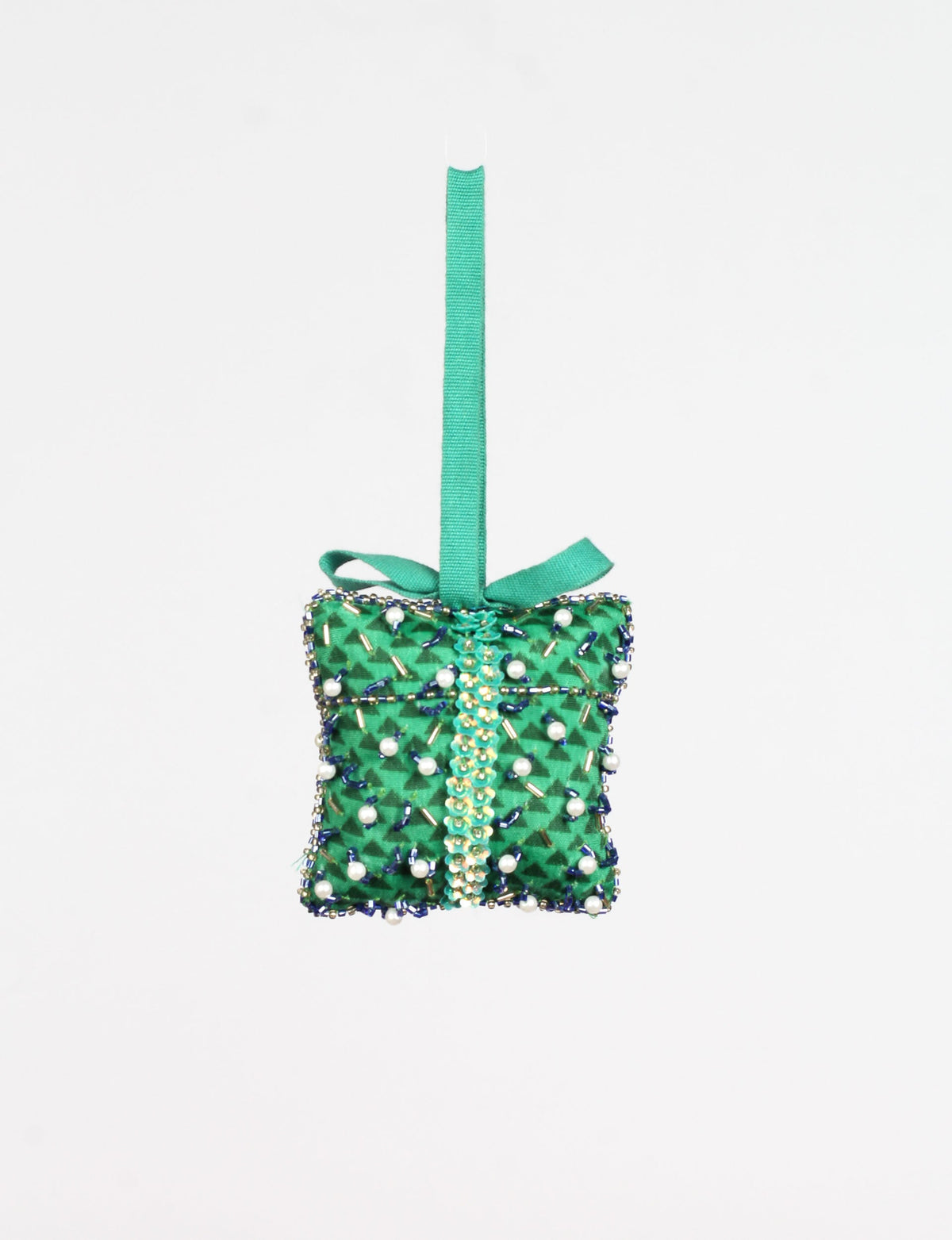 Green fabric gift-shaped ornament with abstract pattern, decorated with beads, pearls, and a green hanging loop with bow