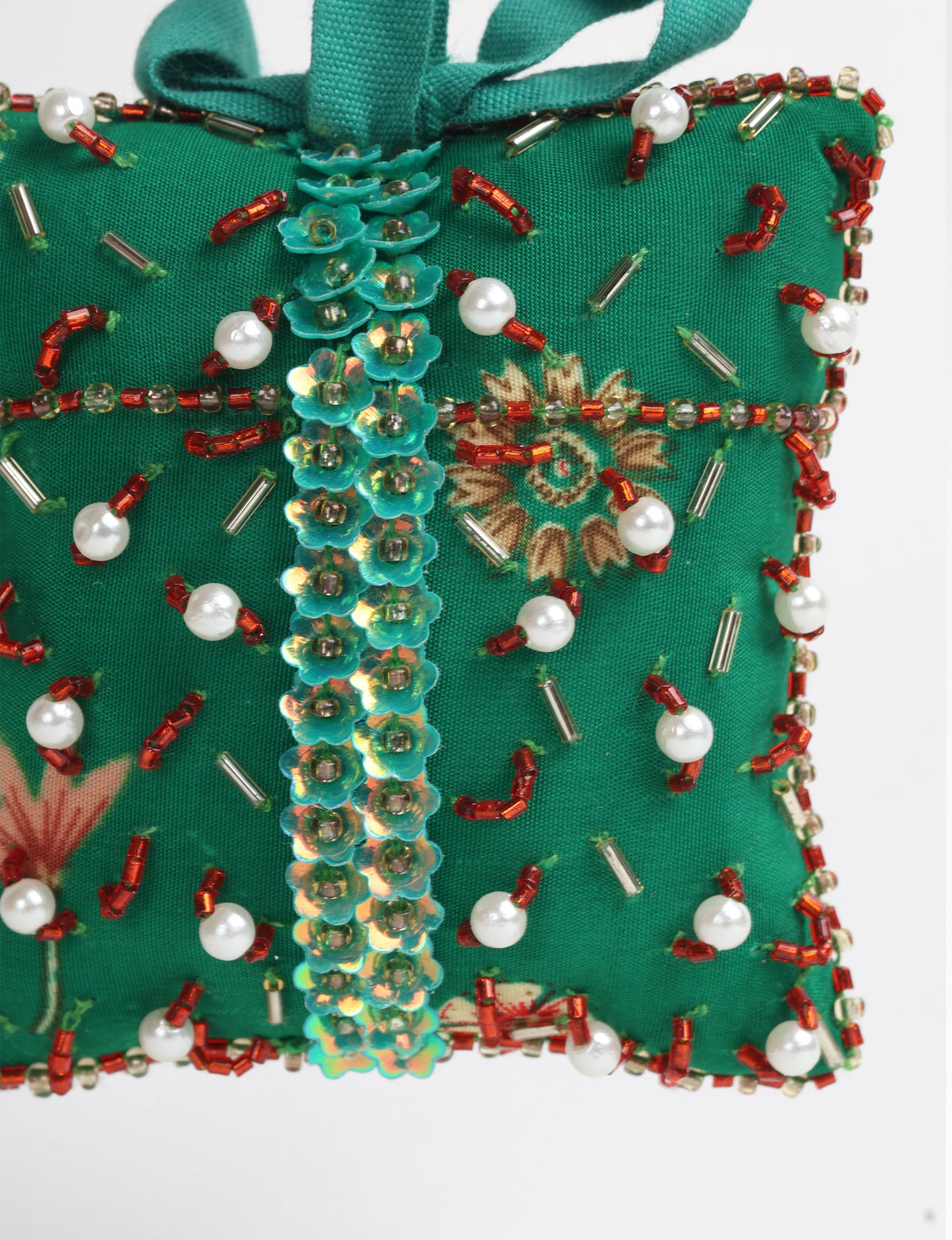 Green fabric gift ornament with red and silver beads, pearl accents, and turquoise flower sequins, hanging loop visible