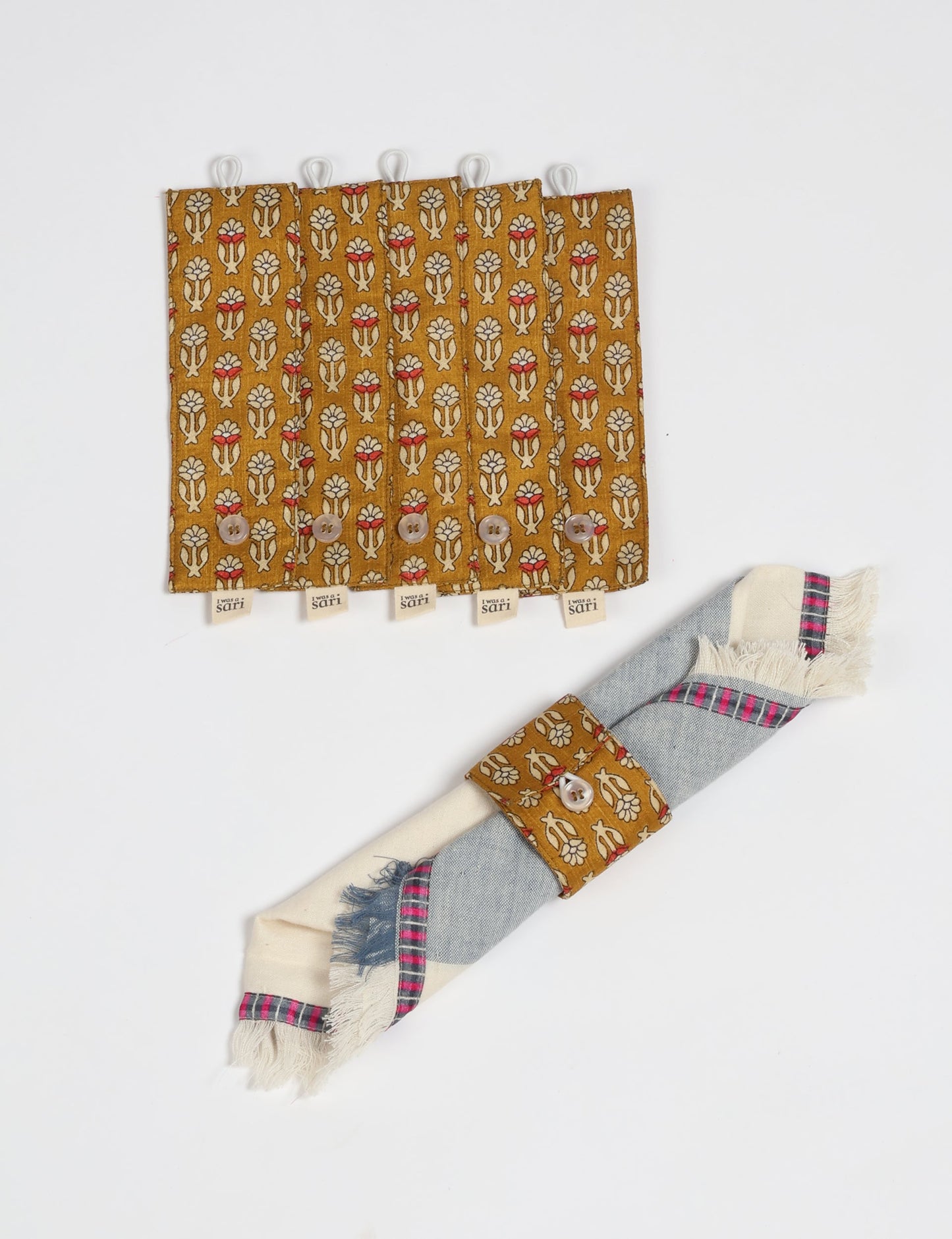 A set of 6 napkin rings made from repurposed saris, showcasing the beauty of sustainable fashion and upcycled materials. These stylish, eco-friendly rings with button closures are ideal for adding a touch of environmentally conscious elegance to your dining table.





