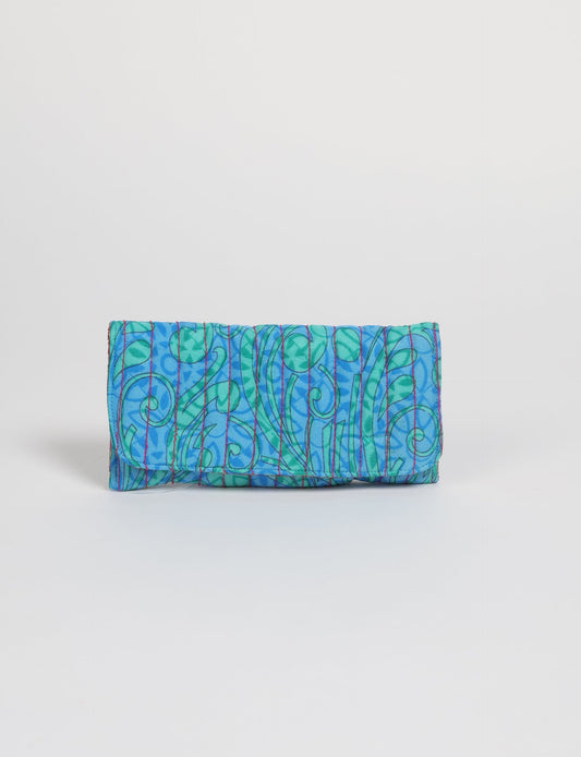 Quilted sunglasses case made from recycled sari products, featuring a secure magnetic closure. A chic example of ethical fashion, conscious clothing, and carbon neutral fashion. Protect your sunglasses while embracing circular fashion and upcycled garments.