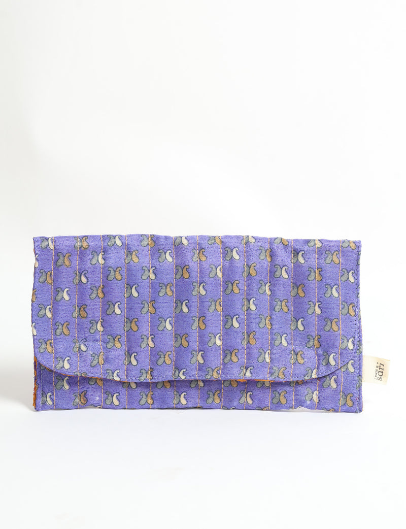 Quilted sunglasses case made from recycled sari products, featuring a secure magnetic closure. A chic example of ethical fashion, conscious clothing, and carbon neutral fashion. Protect your sunglasses while embracing circular fashion and upcycled garments.