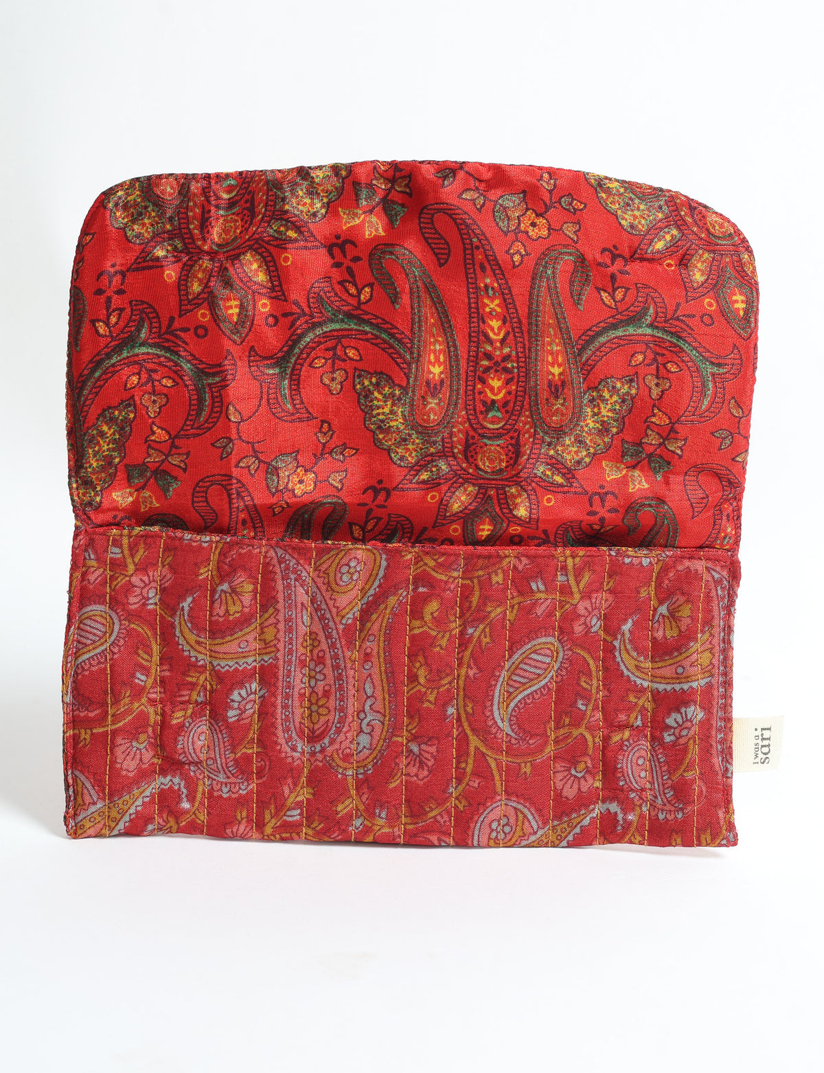 Quilted red fabric sunglasses case with paisley pattern and floral details, open flat with visible stitching and fabric tag