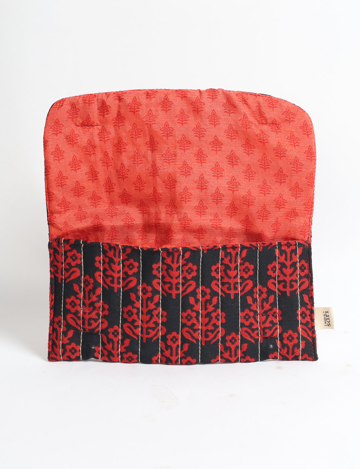 Quilted sunglasses case with black and red floral pattern exterior and red tropical print interior, open flat on white