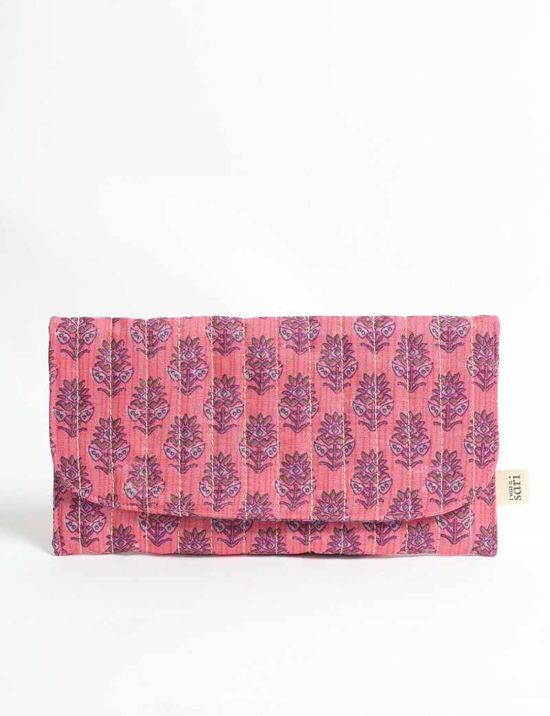 Pink quilted fabric sunglasses case with purple tropical leaf pattern and flap closure, shown front view on white background