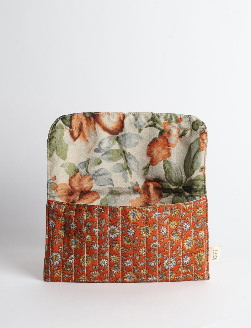 Quilted sunglasses case made from recycled sari products, featuring a secure magnetic closure. A chic example of ethical fashion, conscious clothing, and carbon neutral fashion. Protect your sunglasses while embracing circular fashion and upcycled garments.