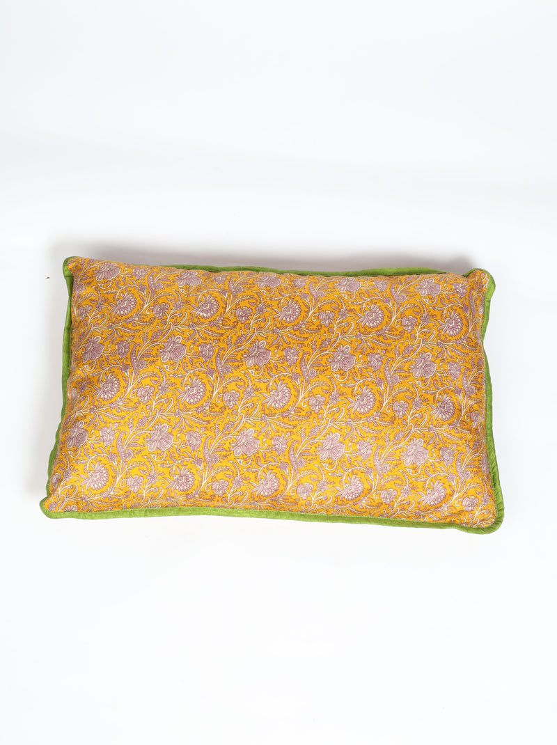 Rectangular lumbar cotton cushion cover with yellow floral pattern and green piping edge, flat lay view on white background