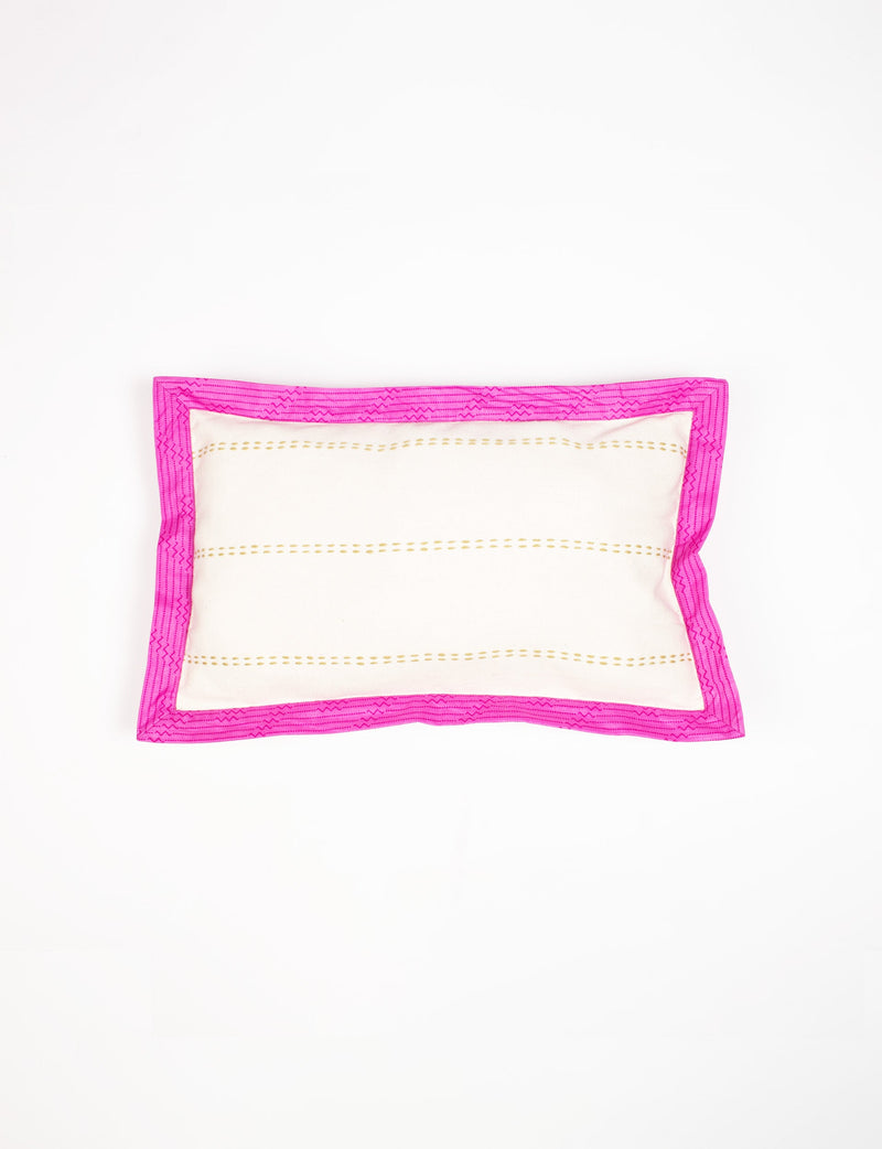 Rectangular lumbar cotton cushion cover with cream center, gold dotted stripes, and broad bright pink sari edging, flat lay