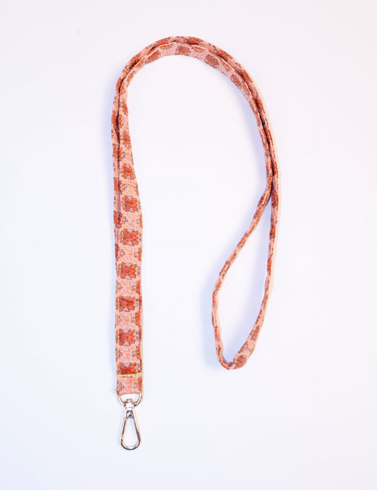 Mobile Phone Lanyard made from recycled sari fabric, featuring repurposed clothing design. Ethical fashion piece promoting eco-friendly fashion, fair trade fashion, and upcycling fashion. Handcrafted by skilled artisans, reflecting recycled material clothing and environmentally friendly clothing trends.