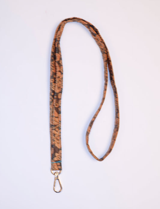 Mobile Phone Lanyard made from recycled sari fabric, featuring repurposed clothing design. Ethical fashion piece promoting eco-friendly fashion, fair trade fashion, and upcycling fashion. Handcrafted by skilled artisans, reflecting recycled material clothing and environmentally friendly clothing trends.