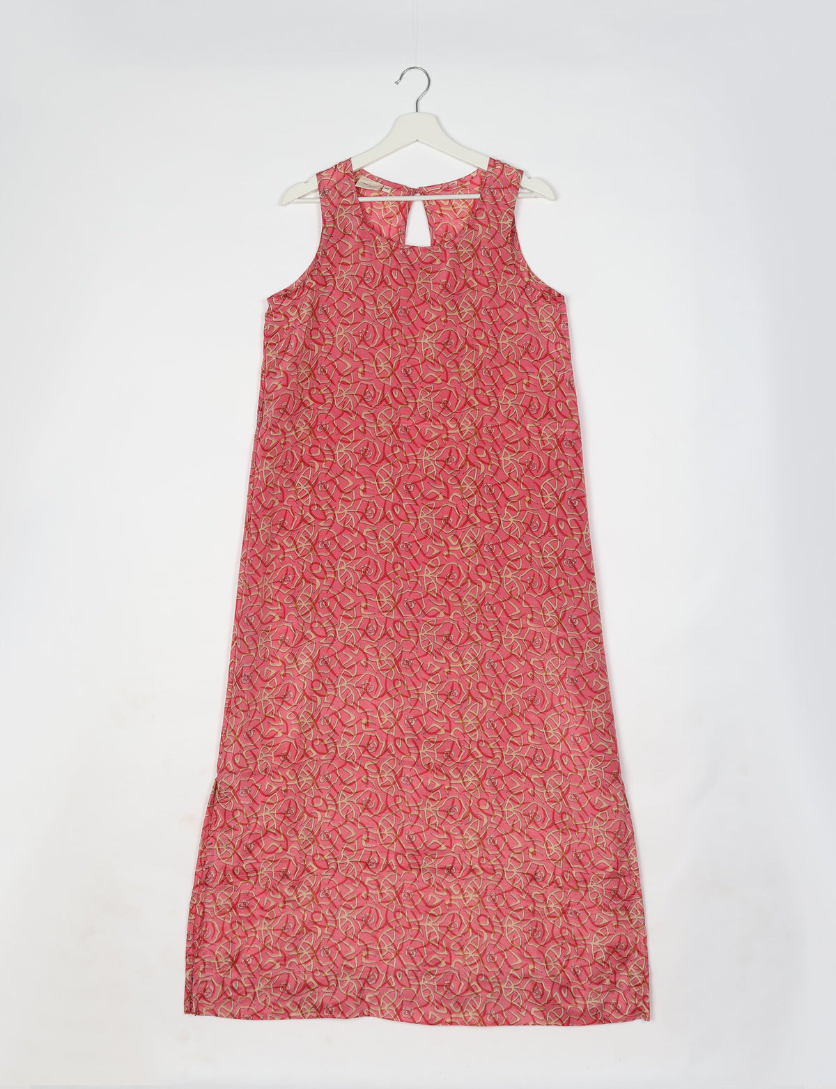 Pink sleeveless A-line maxi dress with abstract leaf and flower pattern, keyhole neckline, hanging on white hanger