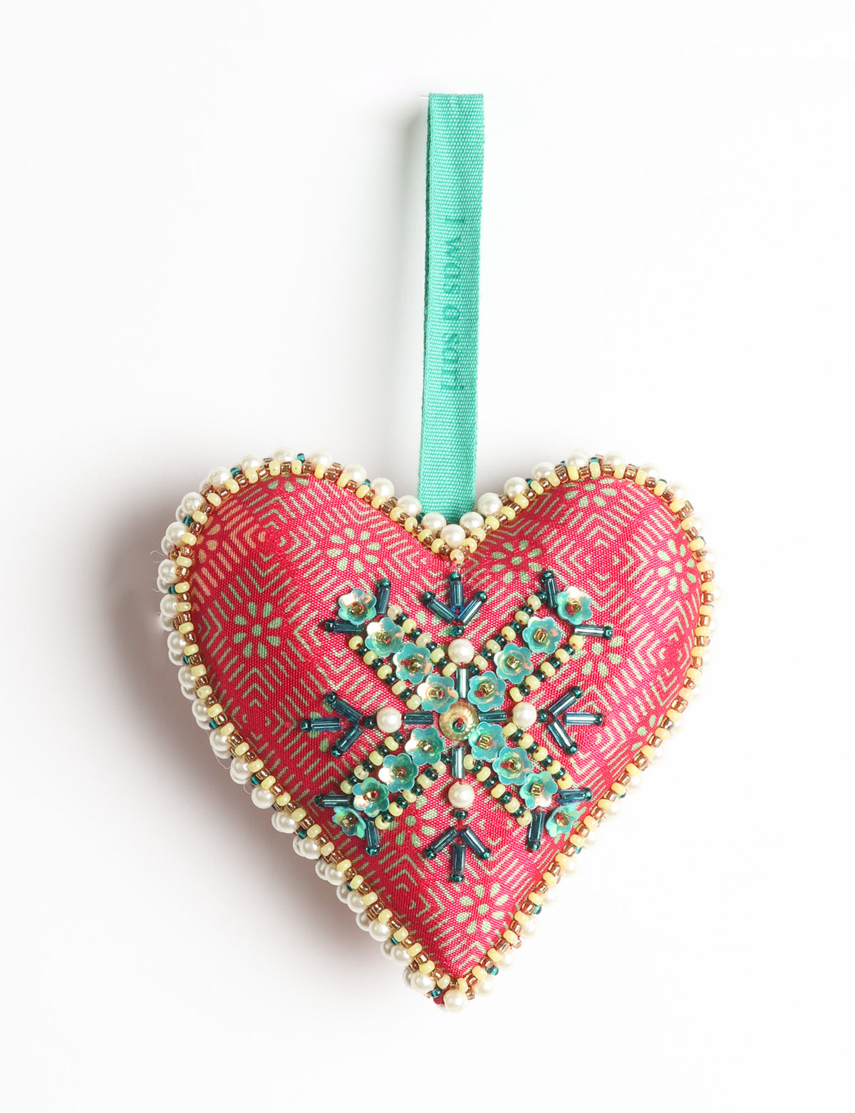 Red fabric heart ornament with yellow floral print, green and pearl bead embellishments, and green hanging loop