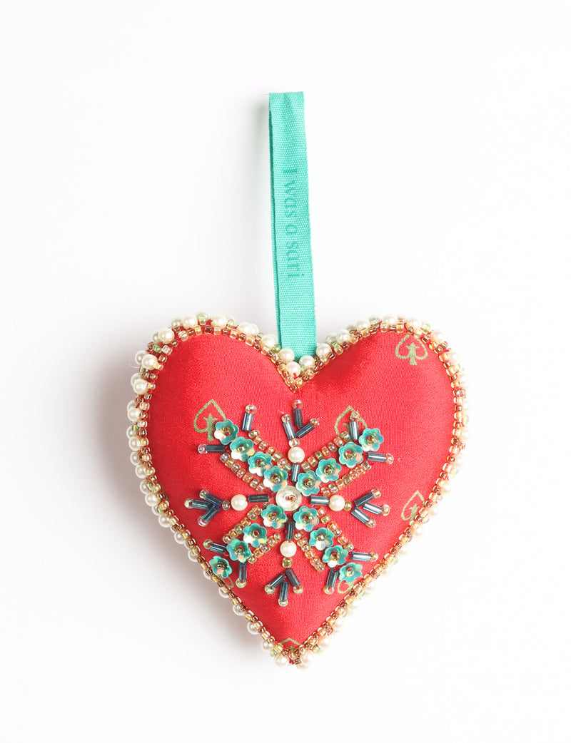 Red fabric heart ornament with yellow floral print, green and pearl bead embellishments, and green hanging loop
