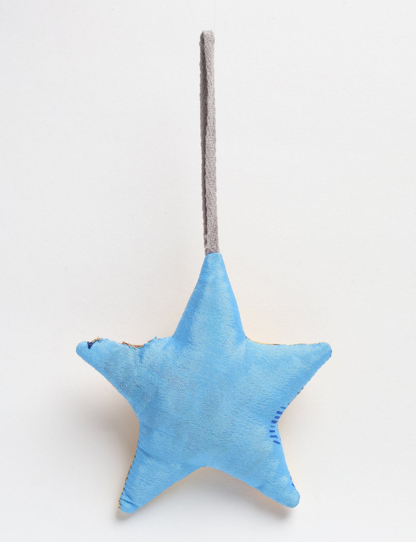 Hand-stitched mini star bauble made from recycled sari products, showcasing upcycled clothing techniques and eco friendly fashion. A lightweight festive accessory promoting conscious clothing, organic clothing, and sustainable women’s clothing crafted from recycled material clothing.