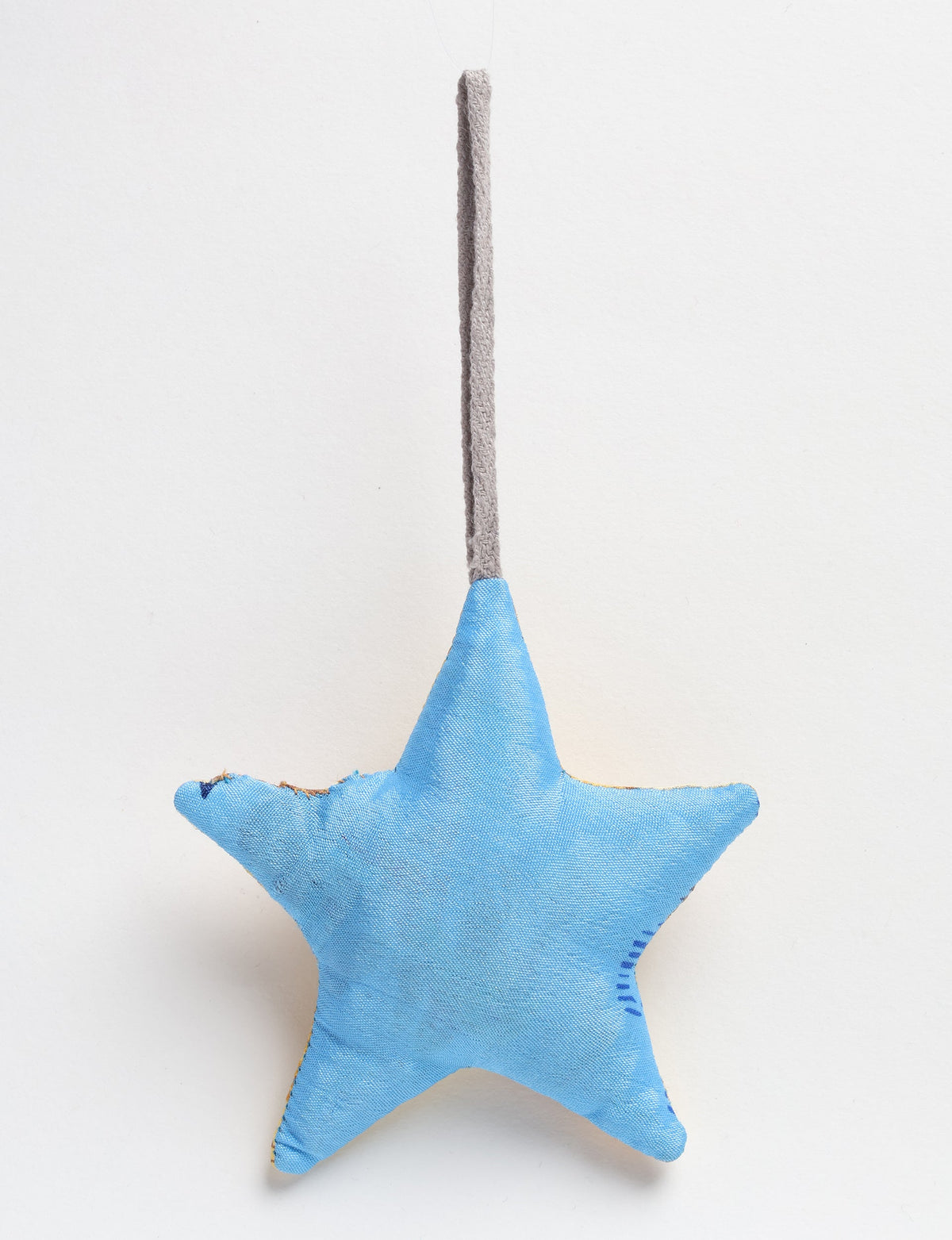 Blue fabric star-shaped bauble with a gray hanging loop, front view on a white background