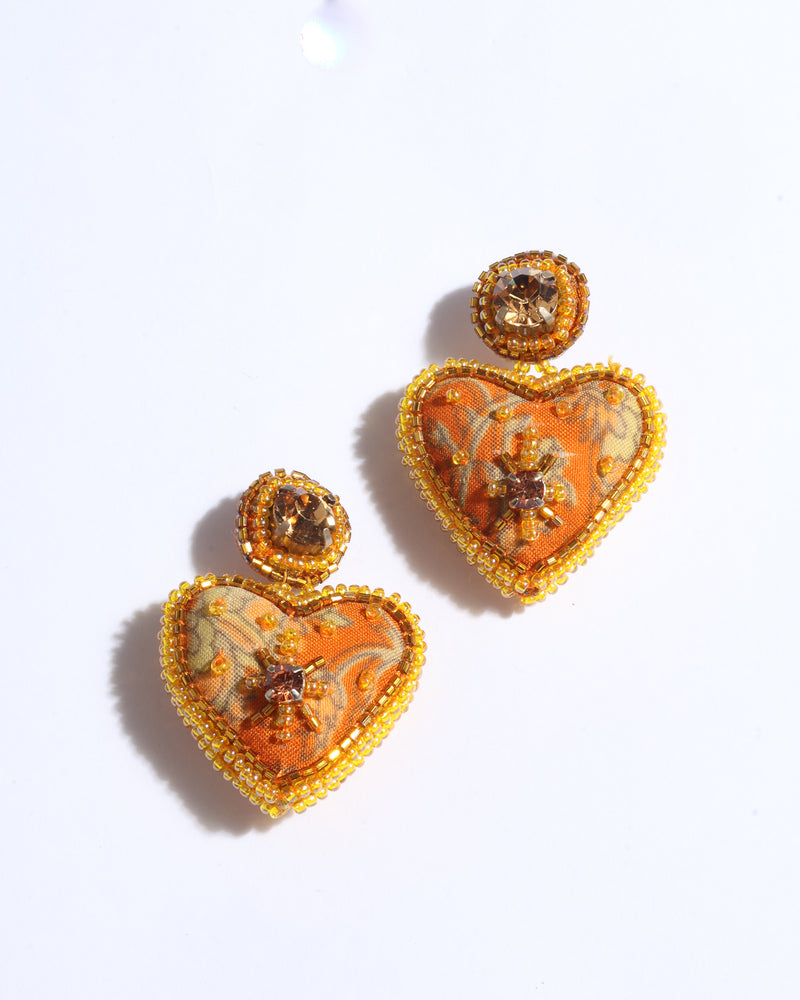Yellow tropical heart drop earrings with bead and rhinestone embellishments, shown flat on white background